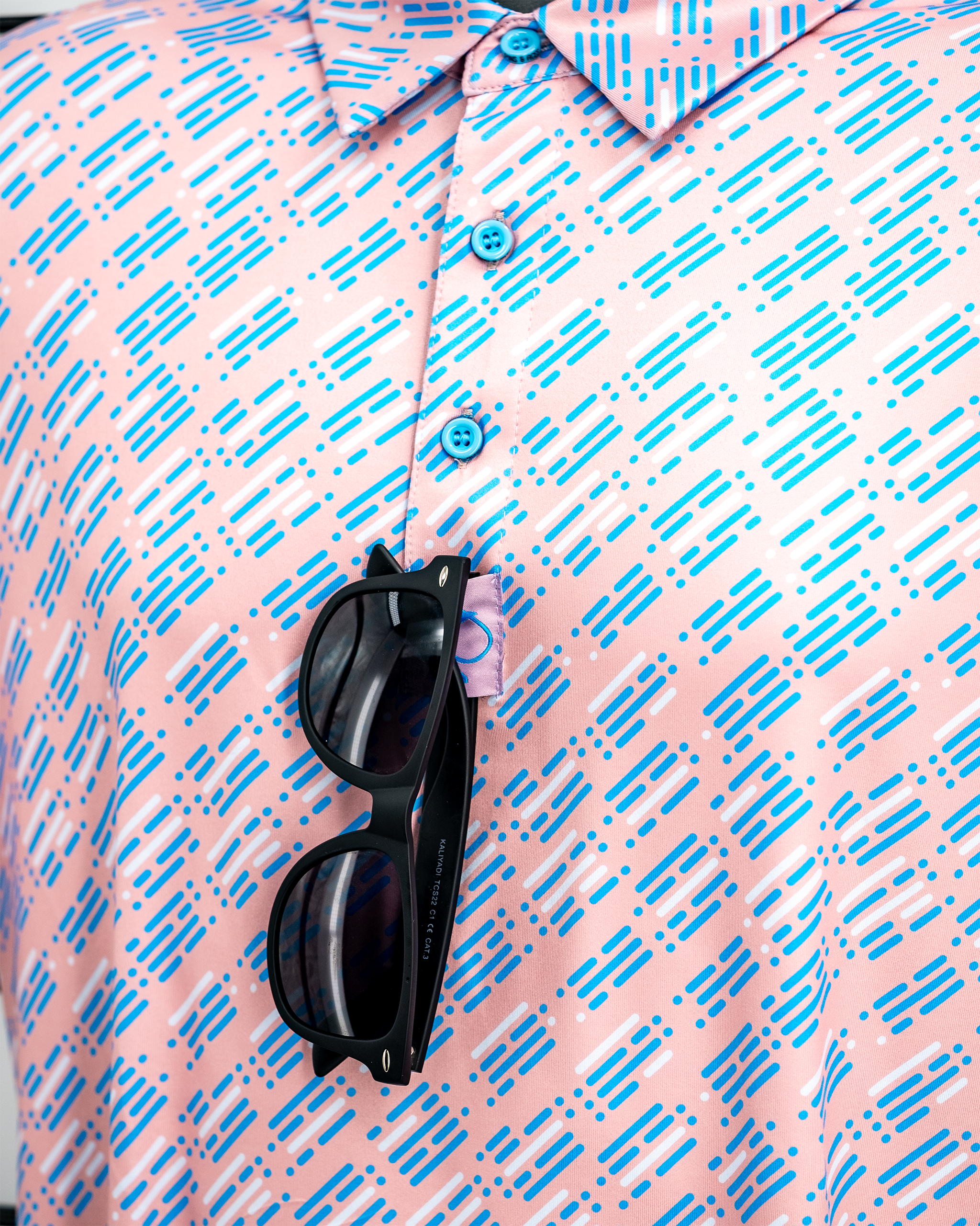 Skyline Dash Pink polo shirt with a modern design and short sleeves, displayed on a neutral background.