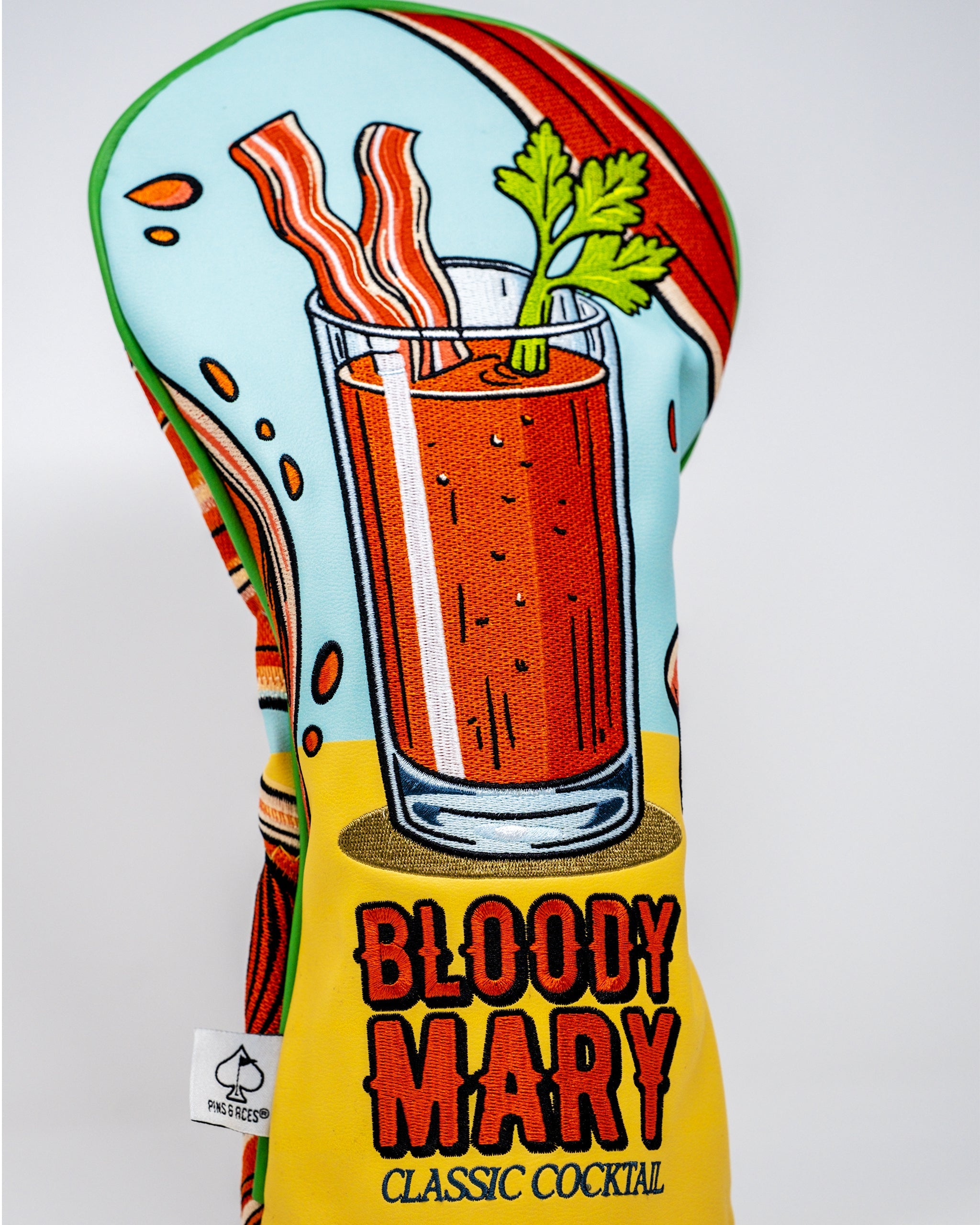 Bloody Mary driver cover featuring a vibrant red design with tomato and celery accents, ideal for golf enthusiasts.