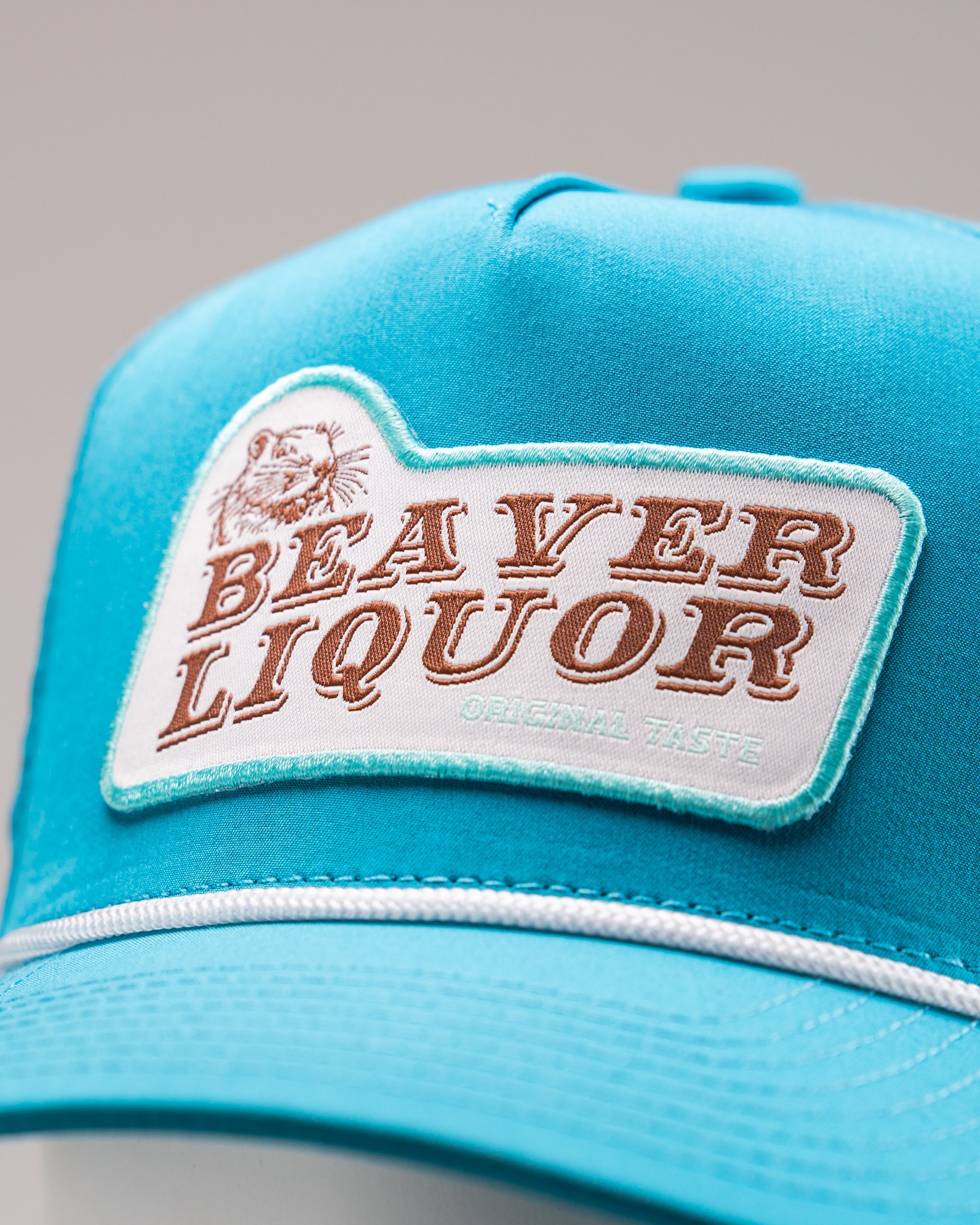 Perforated baby blue rope hat featuring a Beaver Liquor patch.