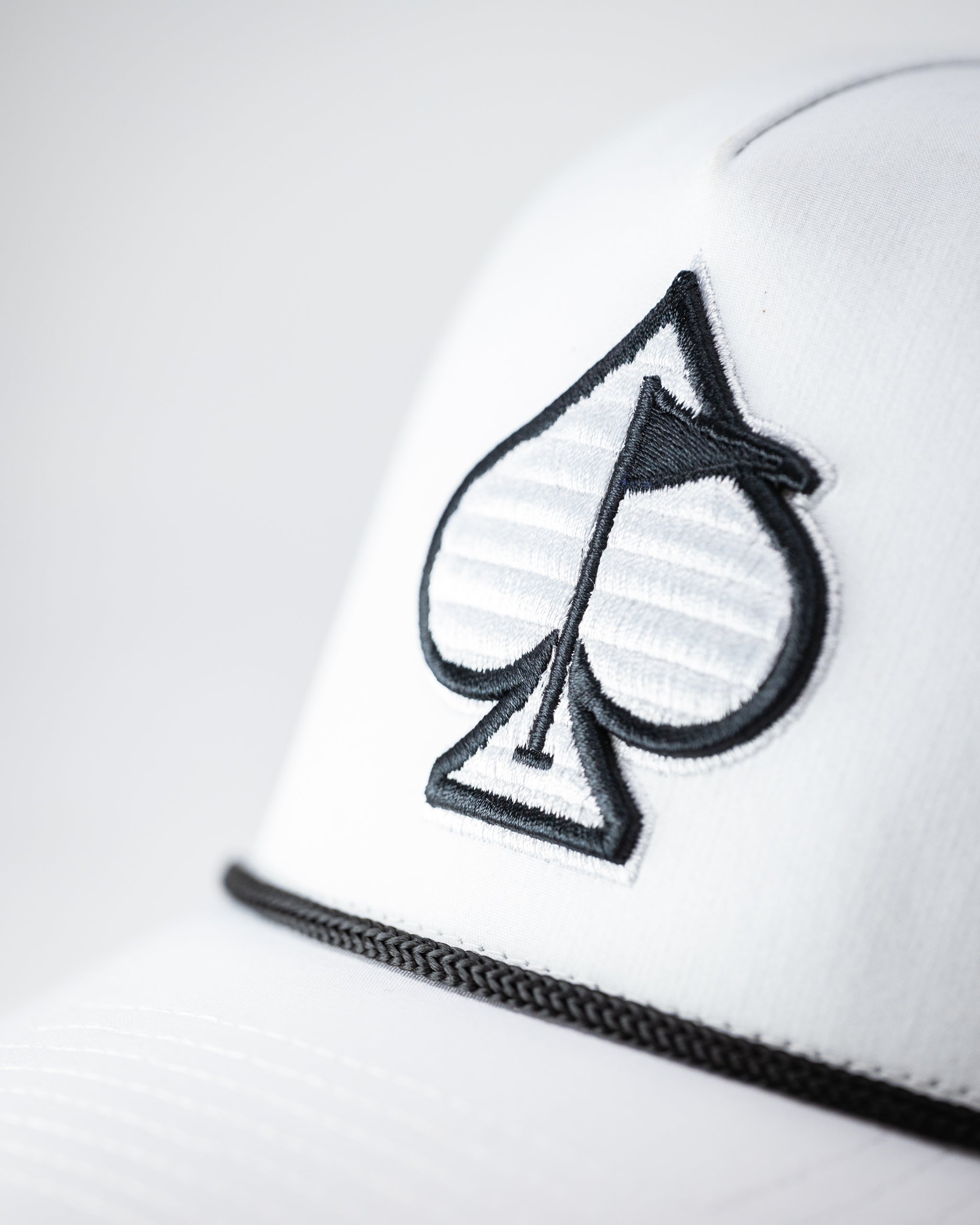 Perforated white rope hat with a stylish design for summer wear.