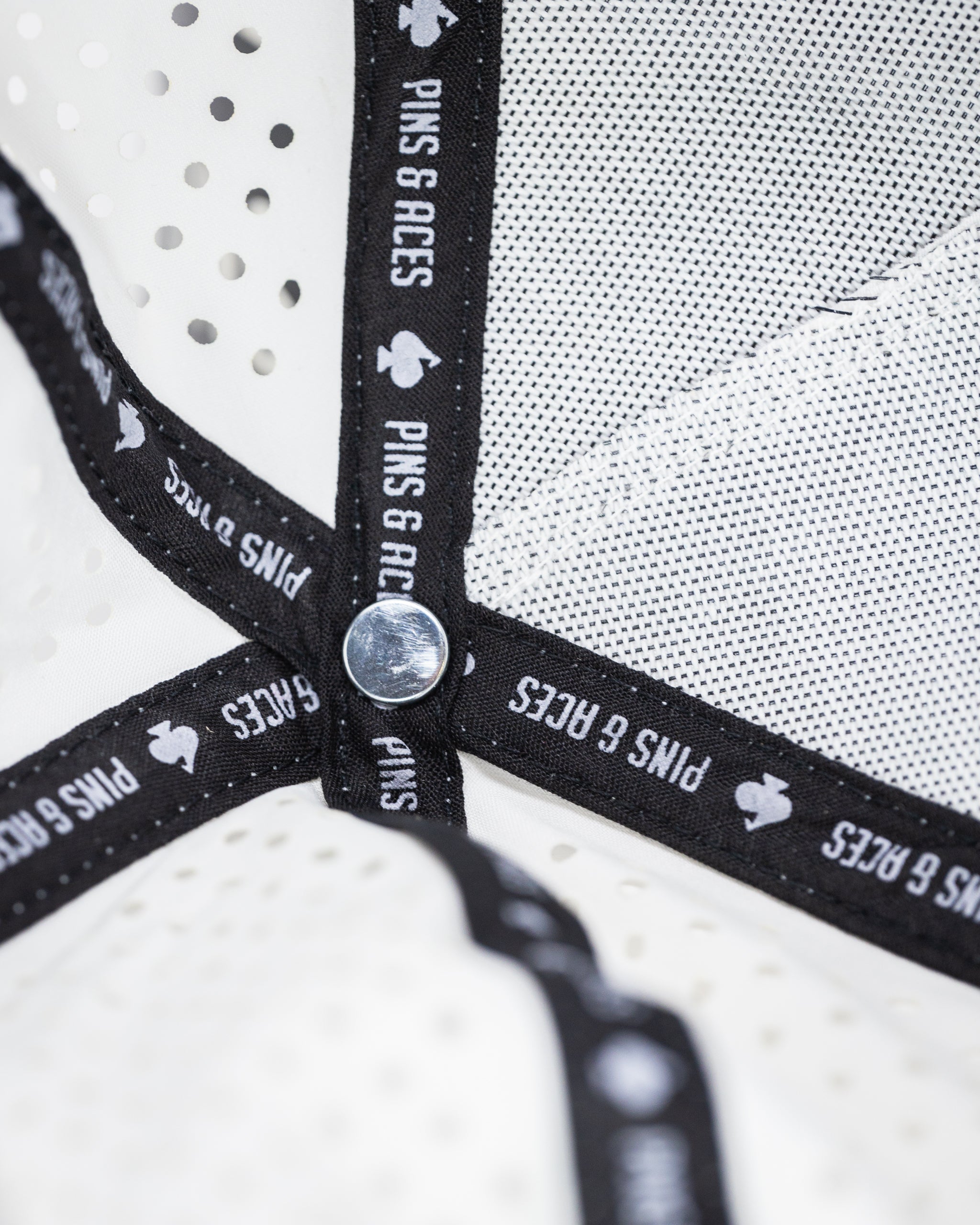 Perforated white rope hat with a stylish design, perfect for summer wear.