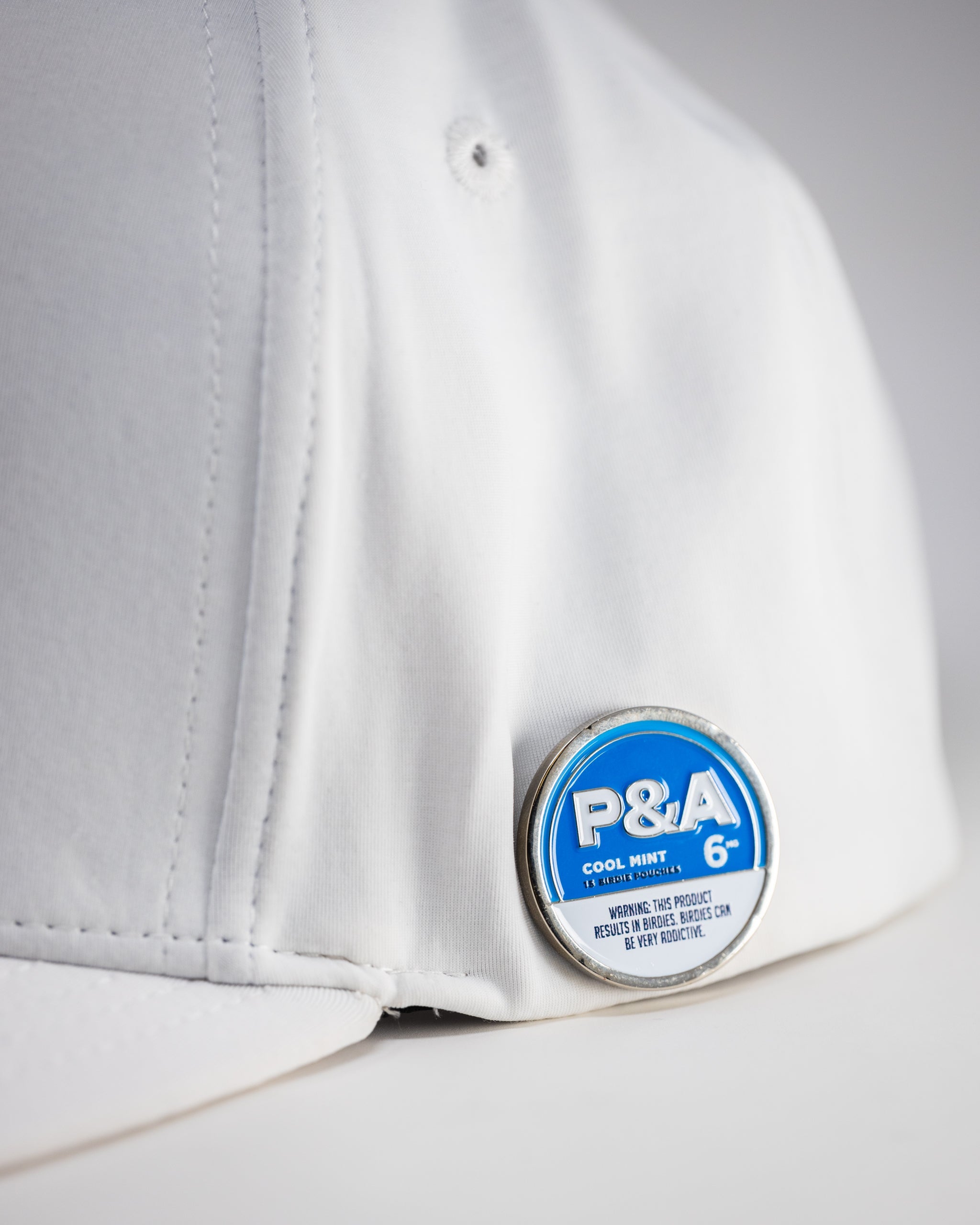 White Performance Spade Hat with a sleek design, featuring a prominent spade logo on the front.