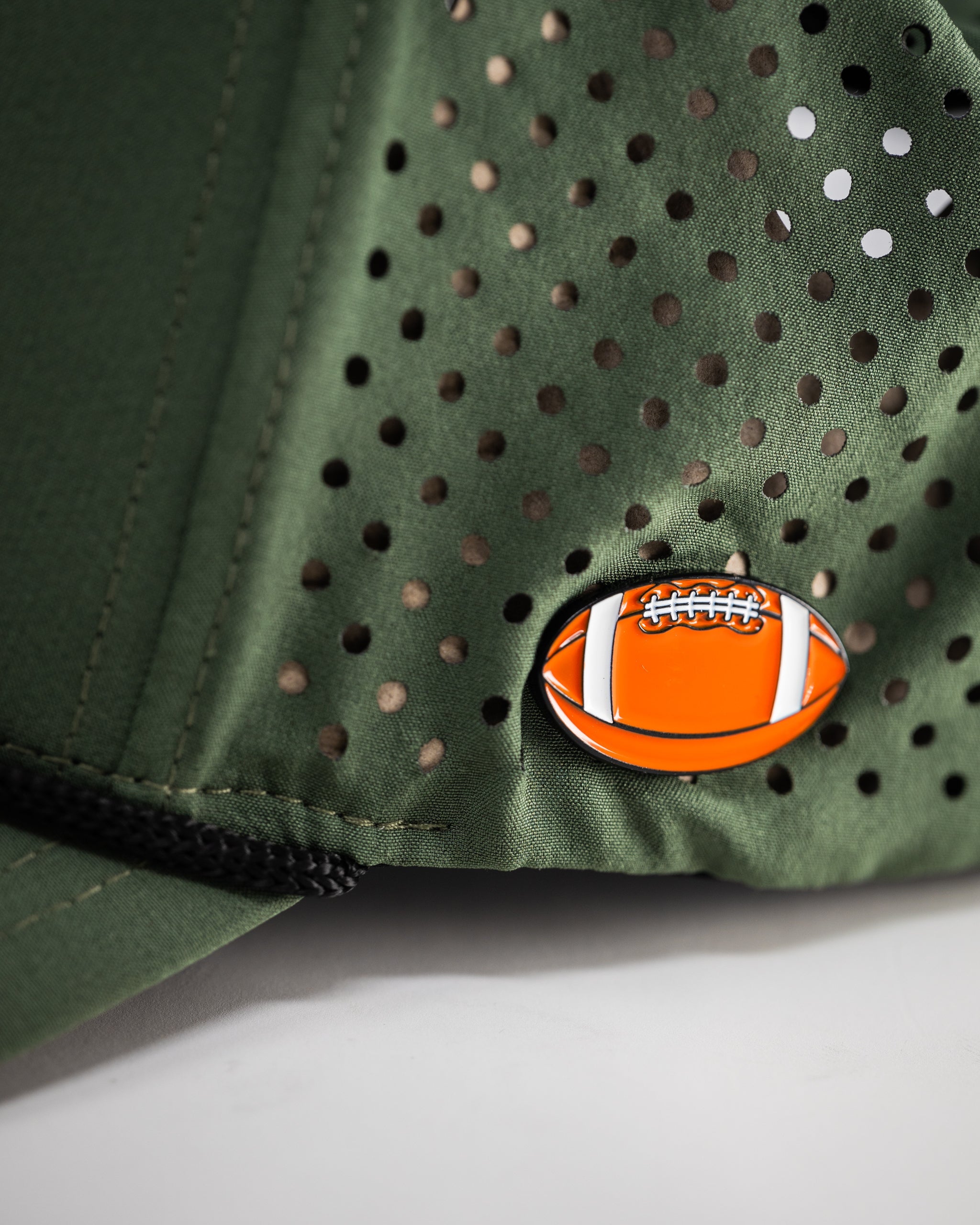 Perforated olive rope hat with a stylish design and adjustable strap.