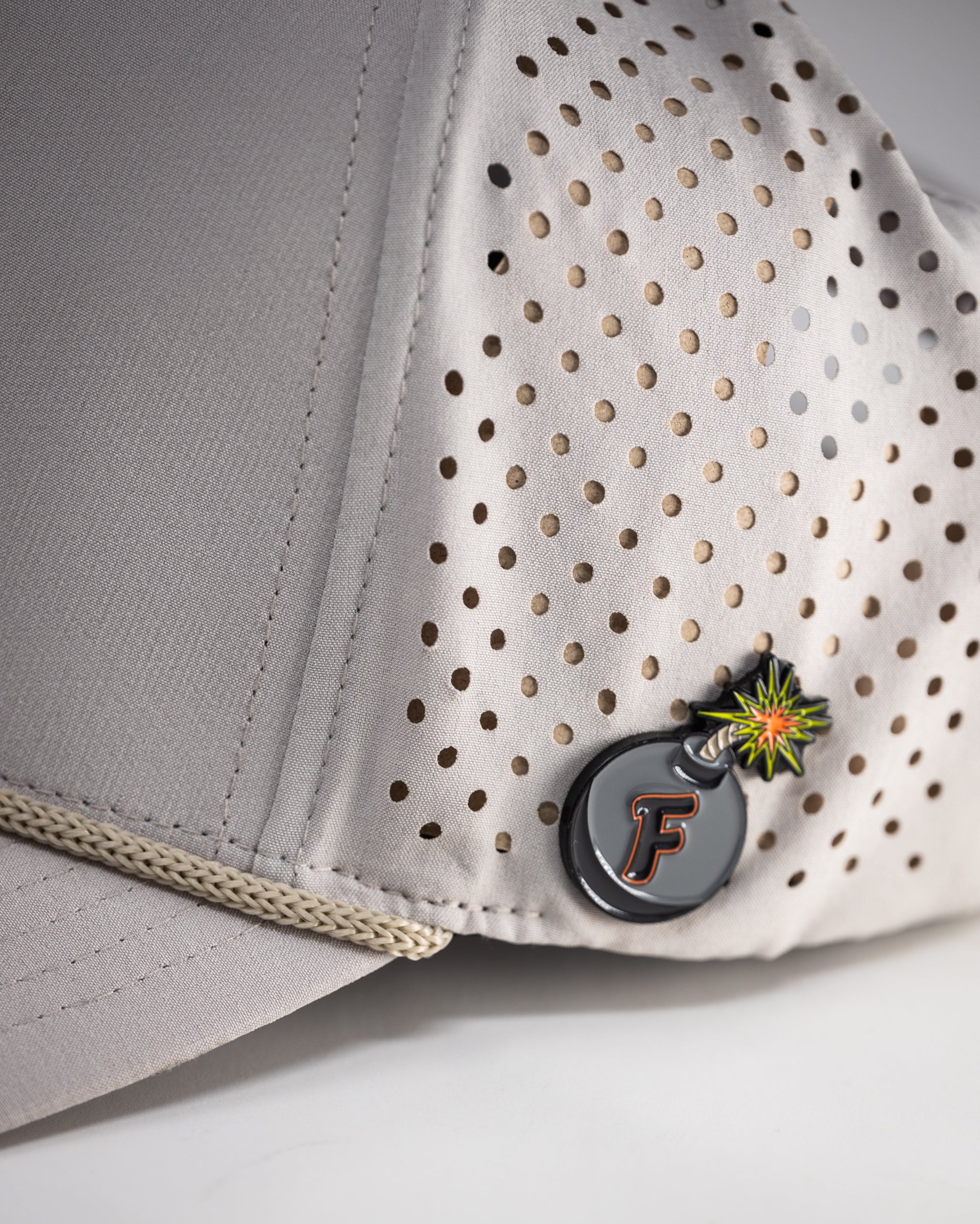 Perforated bone-colored rope hat with a wide brim and adjustable chin strap.