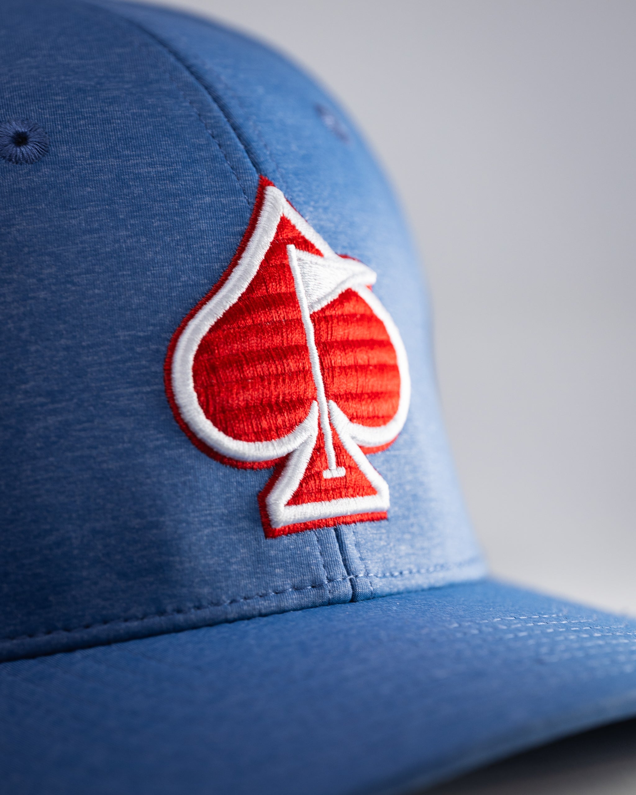 Performance Spade Hat in Blue, featuring a sleek design and breathable fabric, ideal for outdoor activities.