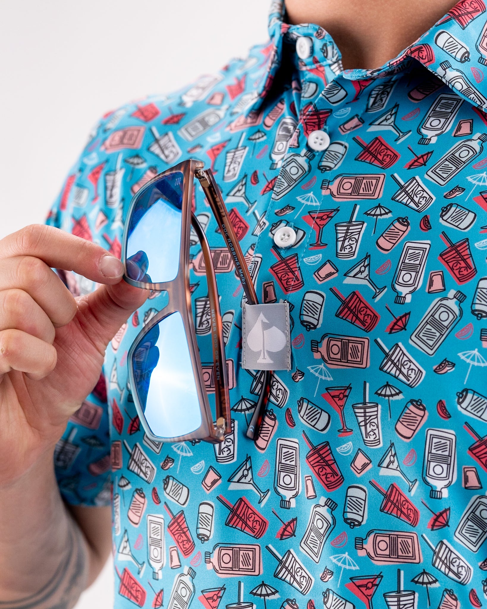 Day Drinker beverage holder with colorful graphics and a straw, featuring an insulated design for outdoor use.