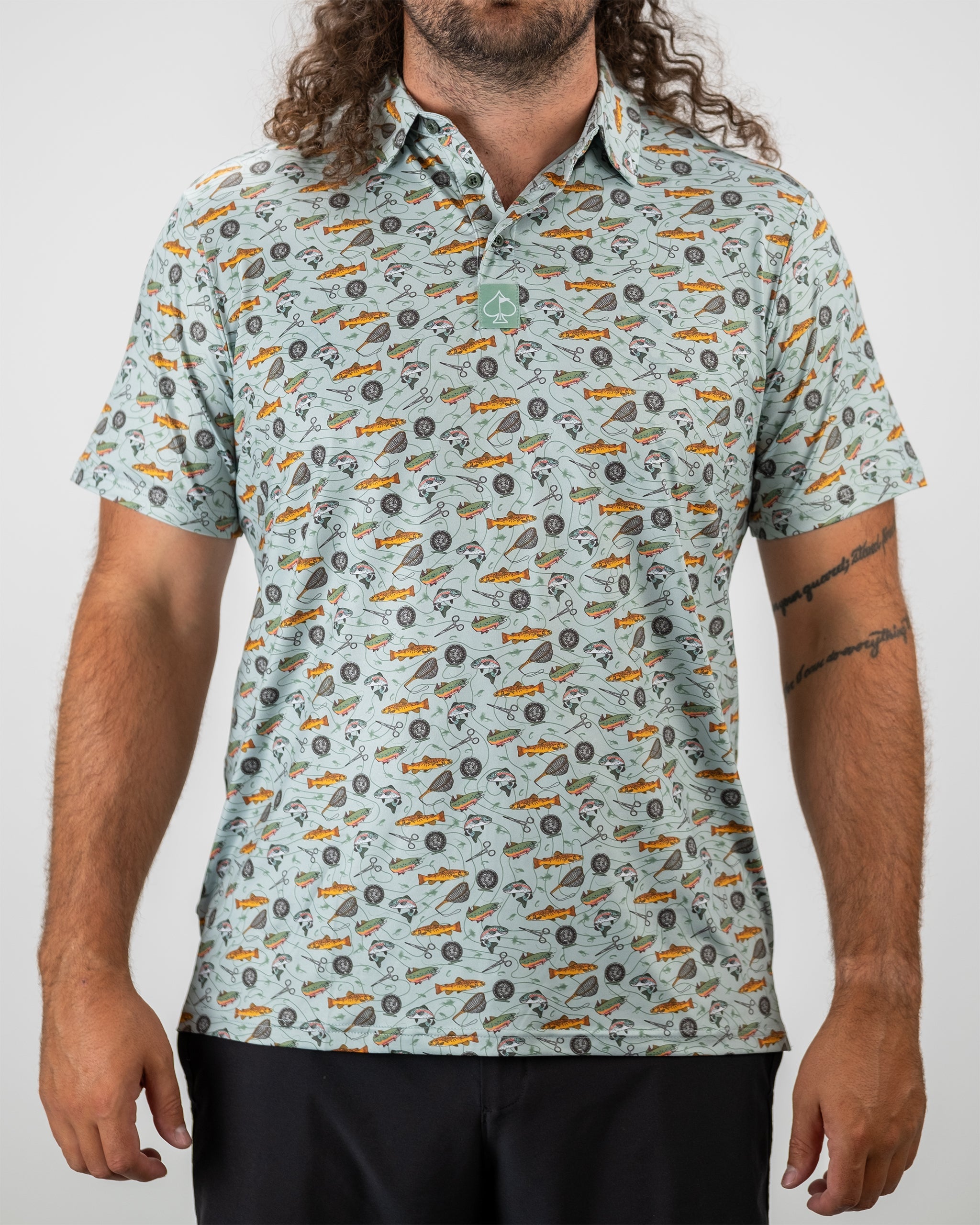 Model showcasing the "Catch and Release" fishing-themed apparel on a rocky shoreline.