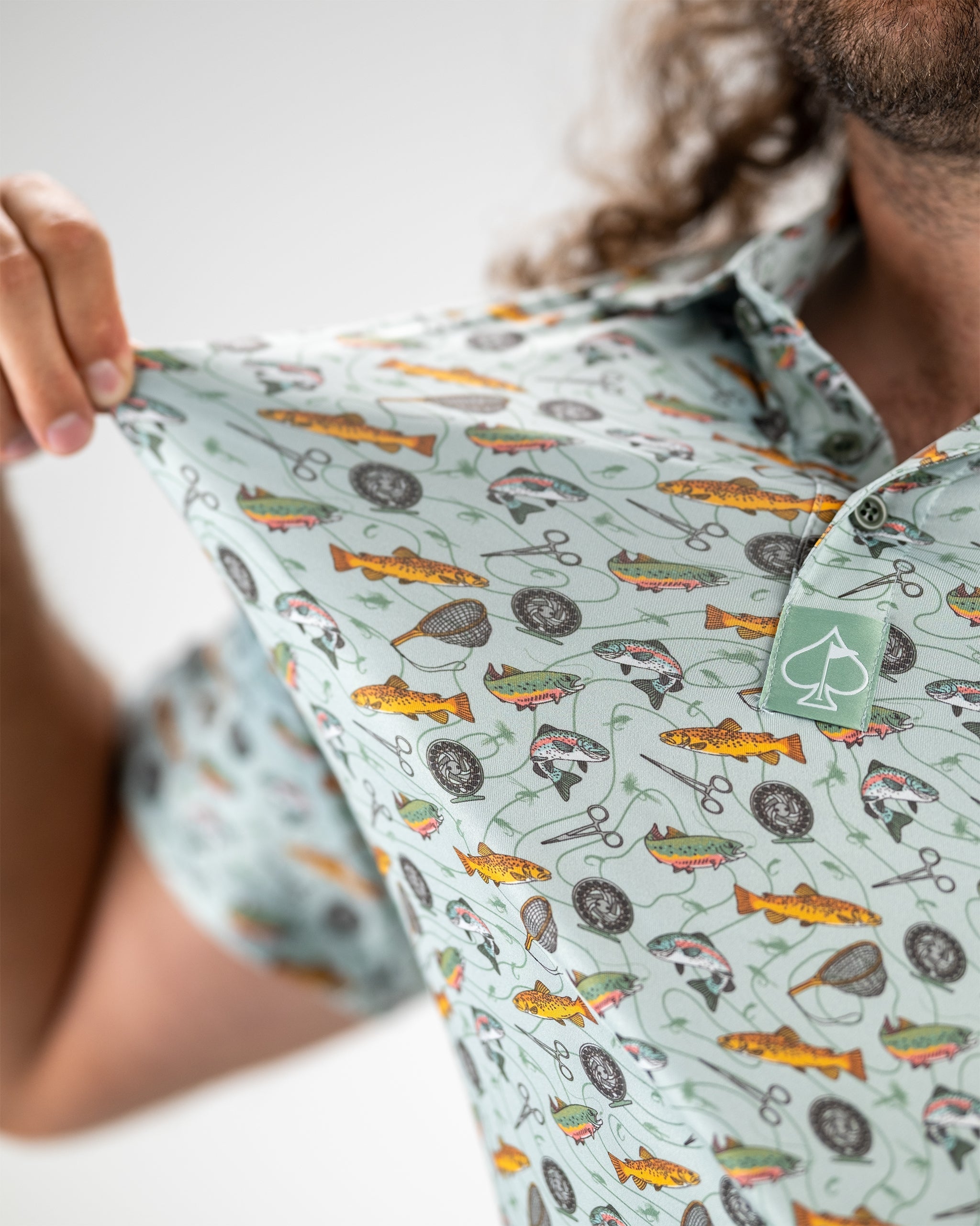 "Model wearing a Catch and Release graphic t-shirt in a casual outdoor setting."