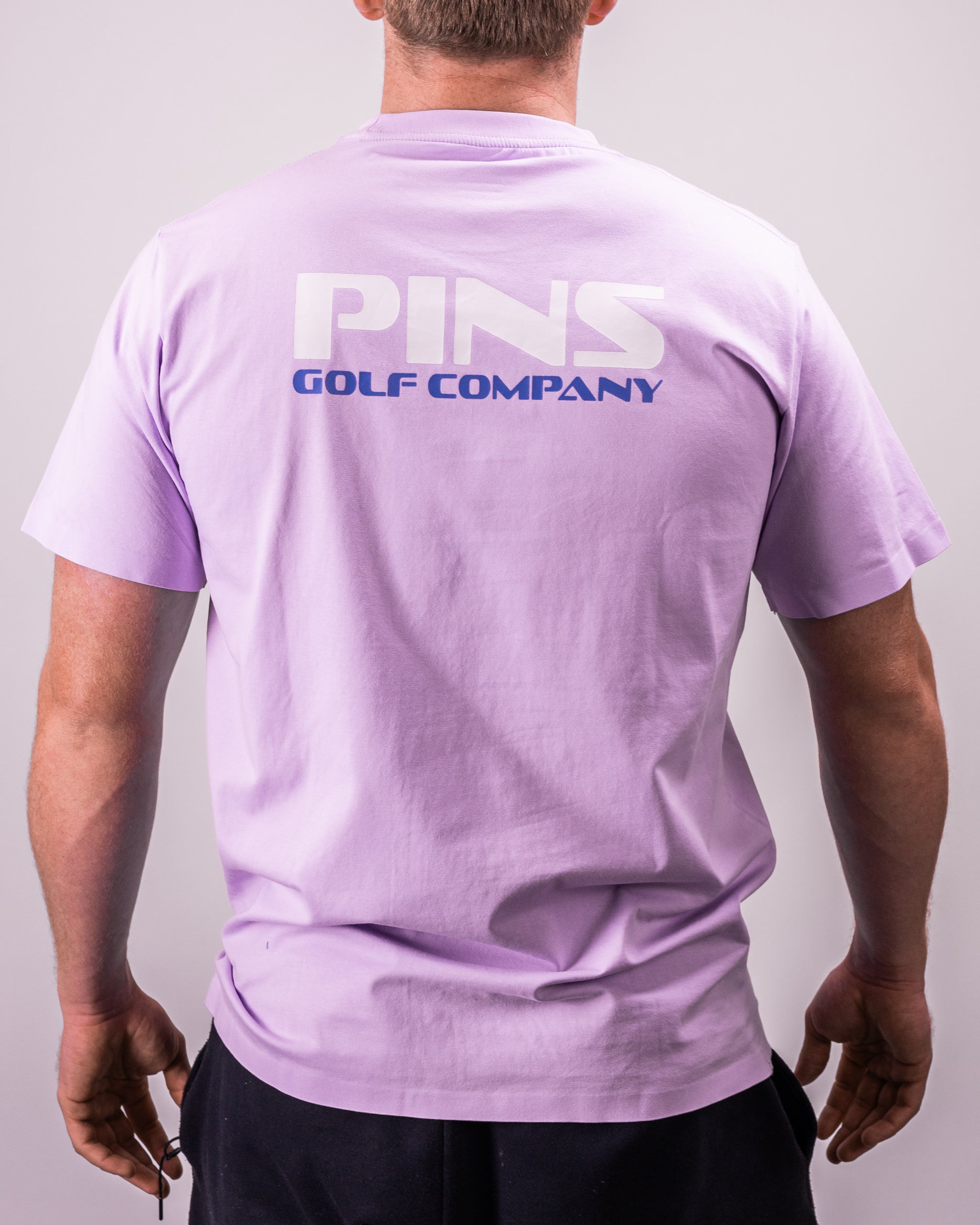 Black Streamliner tee displayed on a model outdoors, showcasing a minimalist design with a relaxed fit.