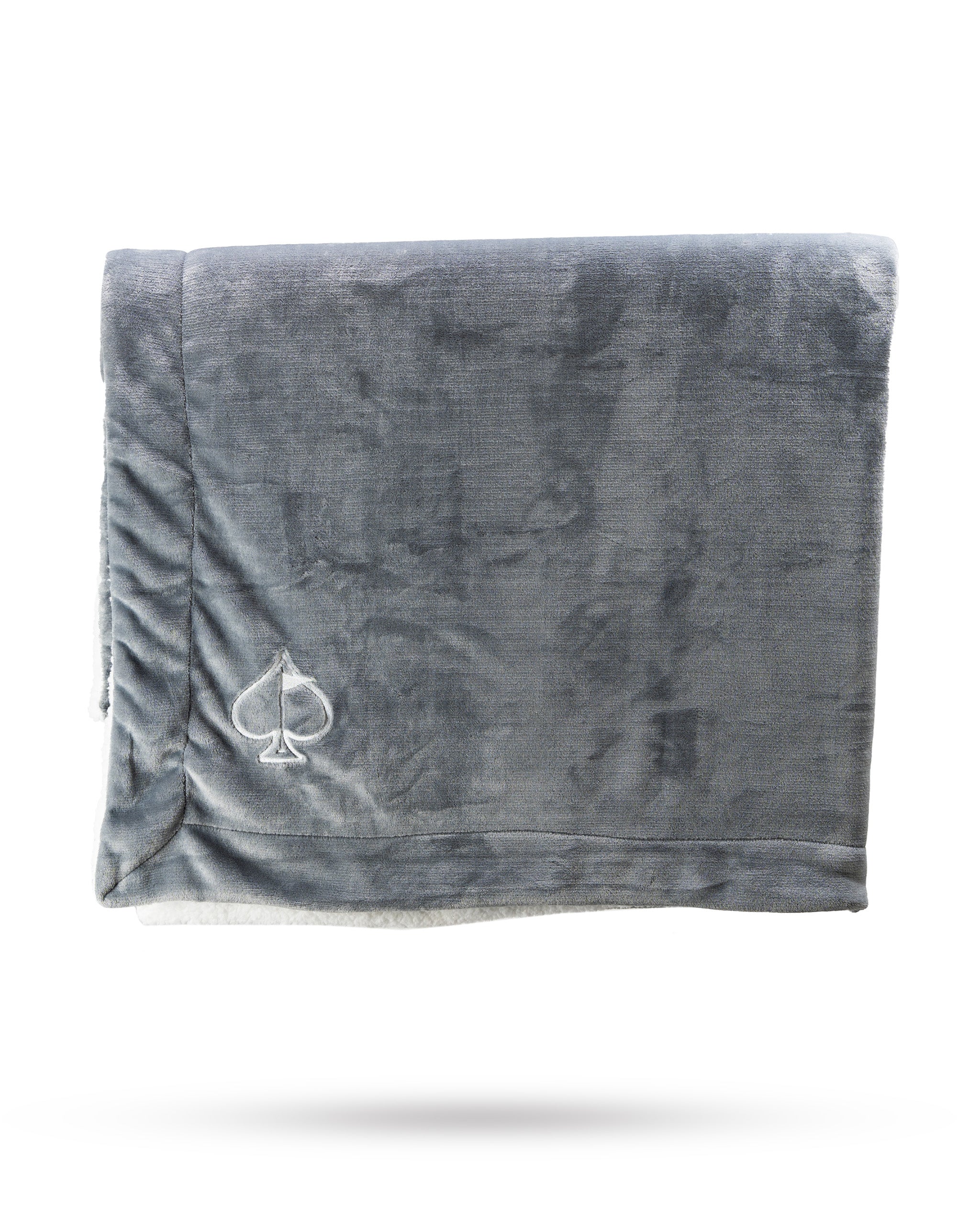 Light gray Bogey Blanket displayed on a soft surface, showcasing its plush texture and cozy appearance.