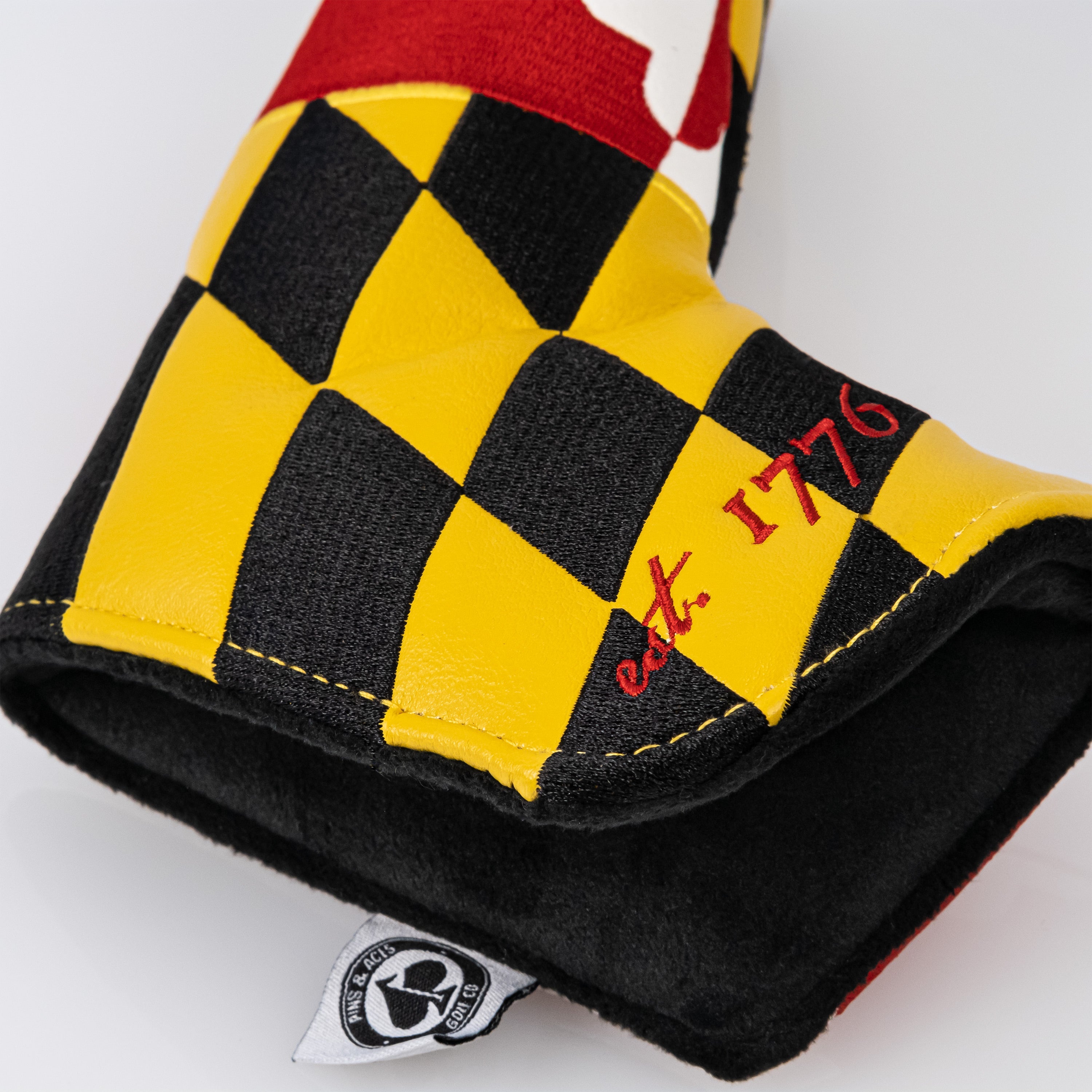 Maryland blade putter cover featuring a vibrant Maryland flag design, showcasing an open view with soft interior cushioning.
