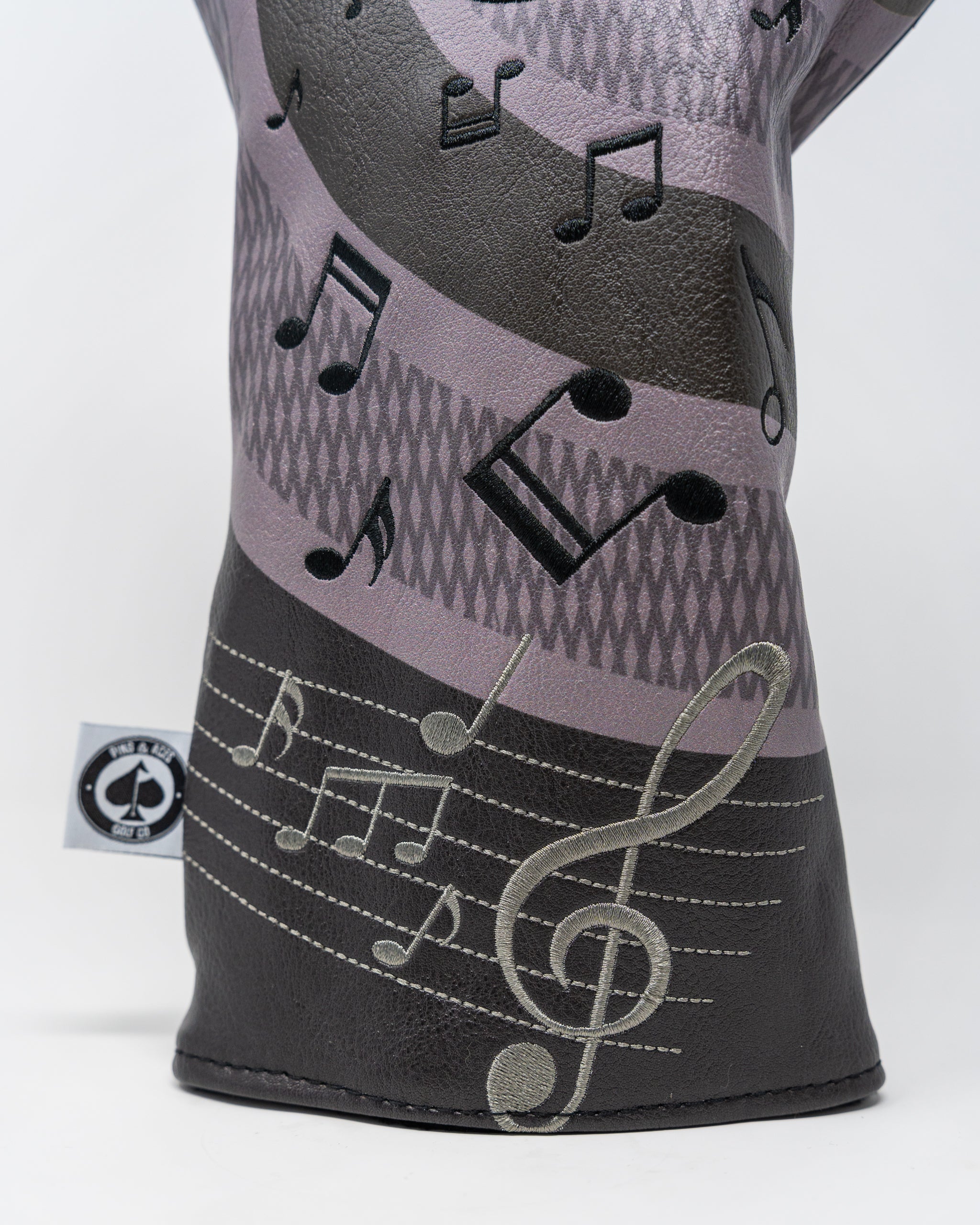 "Music City driver headcover featuring a vibrant design with musical notes and city skyline motifs."