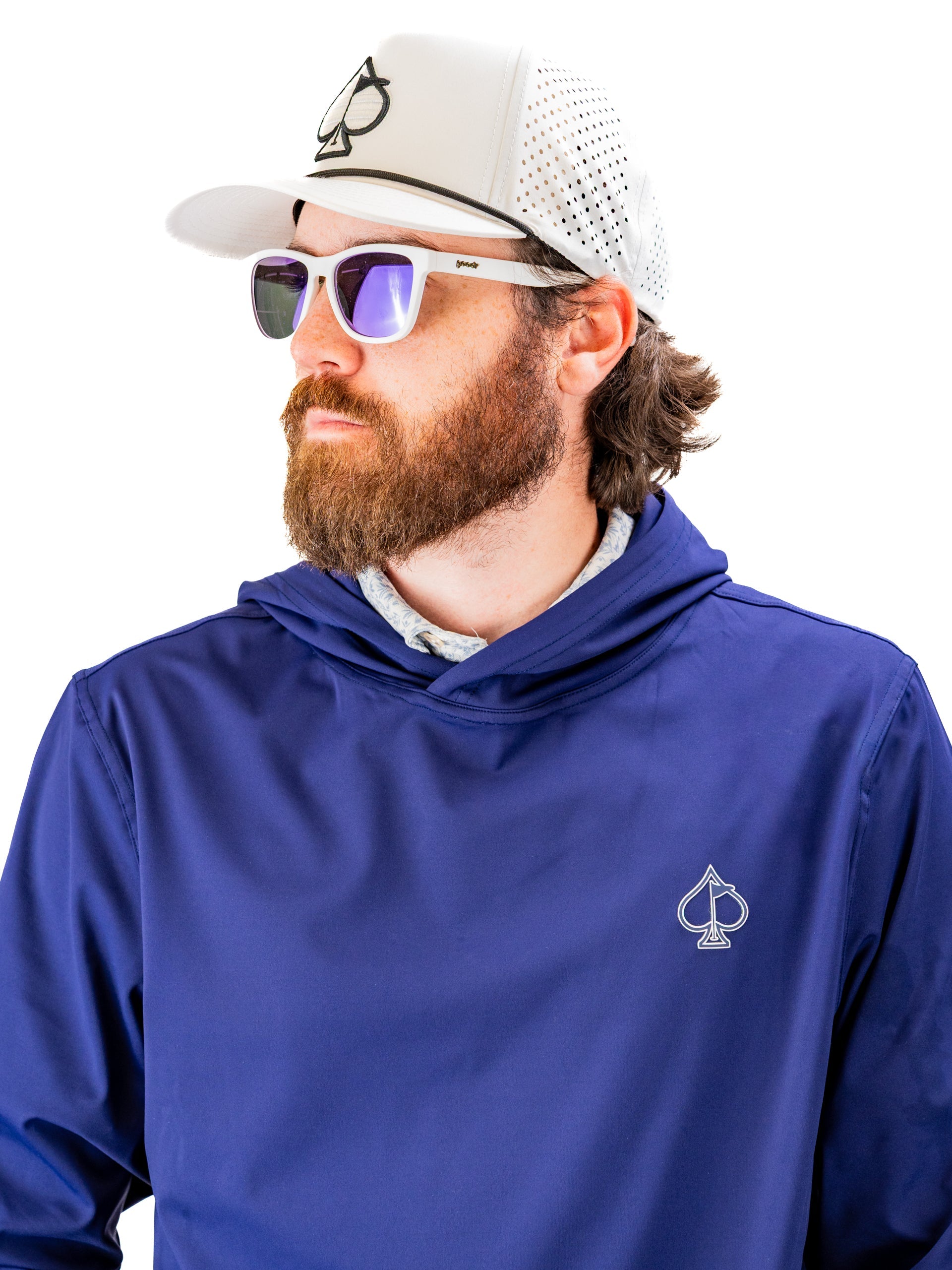 Navy performance golf hoodie featuring a logo, worn by a man with sunglasses and a cap, ideal for stylish golfers.