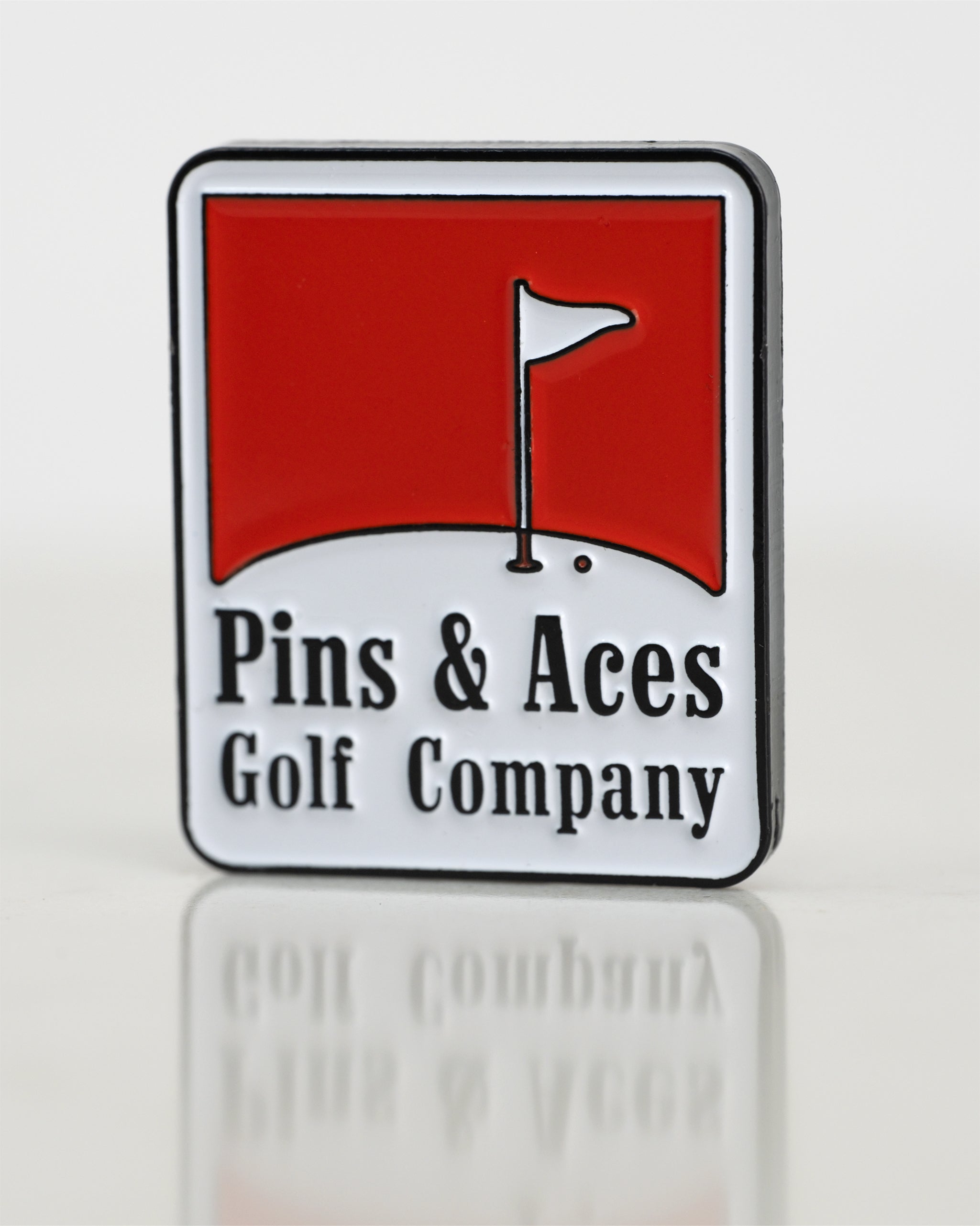Red ball marker with a circular design, featuring a glossy finish and the brand logo prominently displayed in the center.