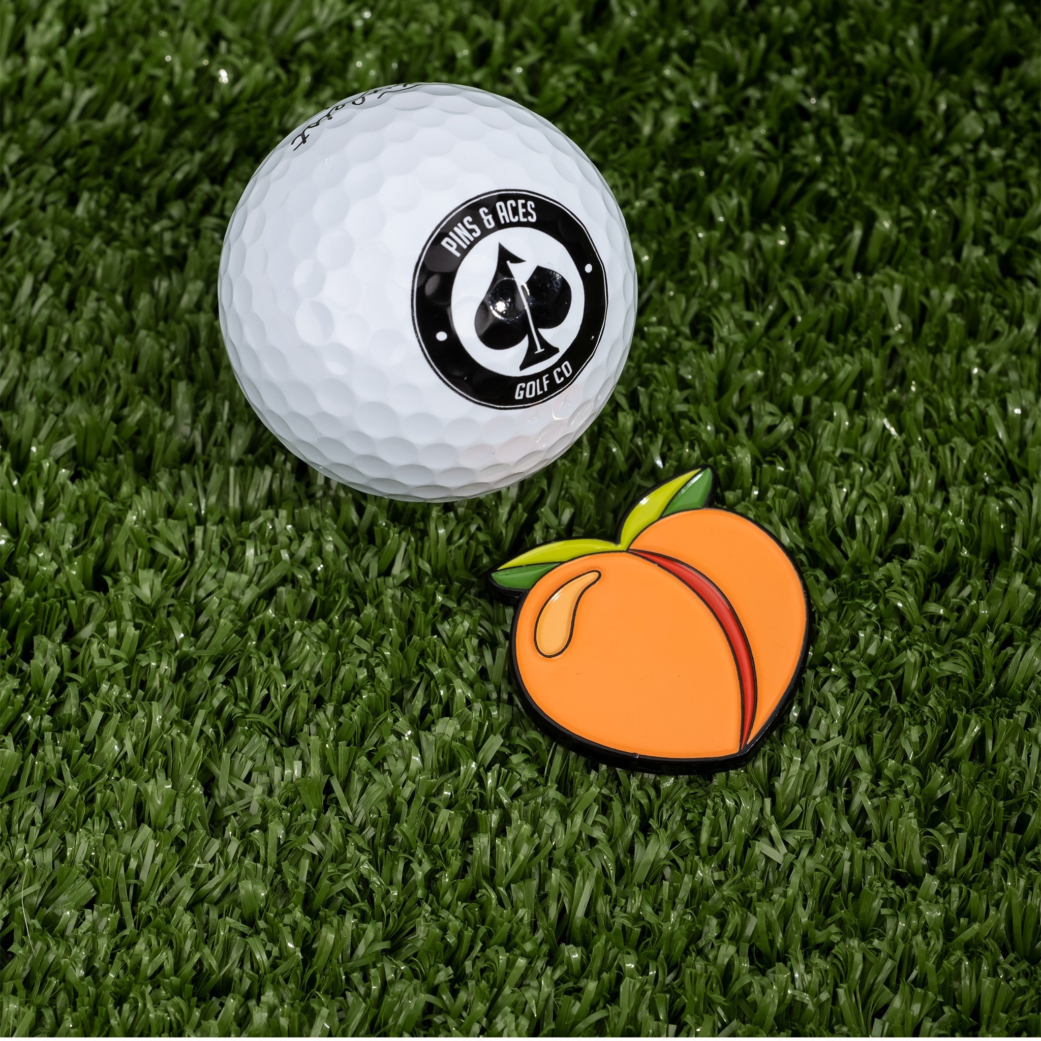 Peach-colored ball marker for golf, featuring a smooth surface and round design, placed on a white background.