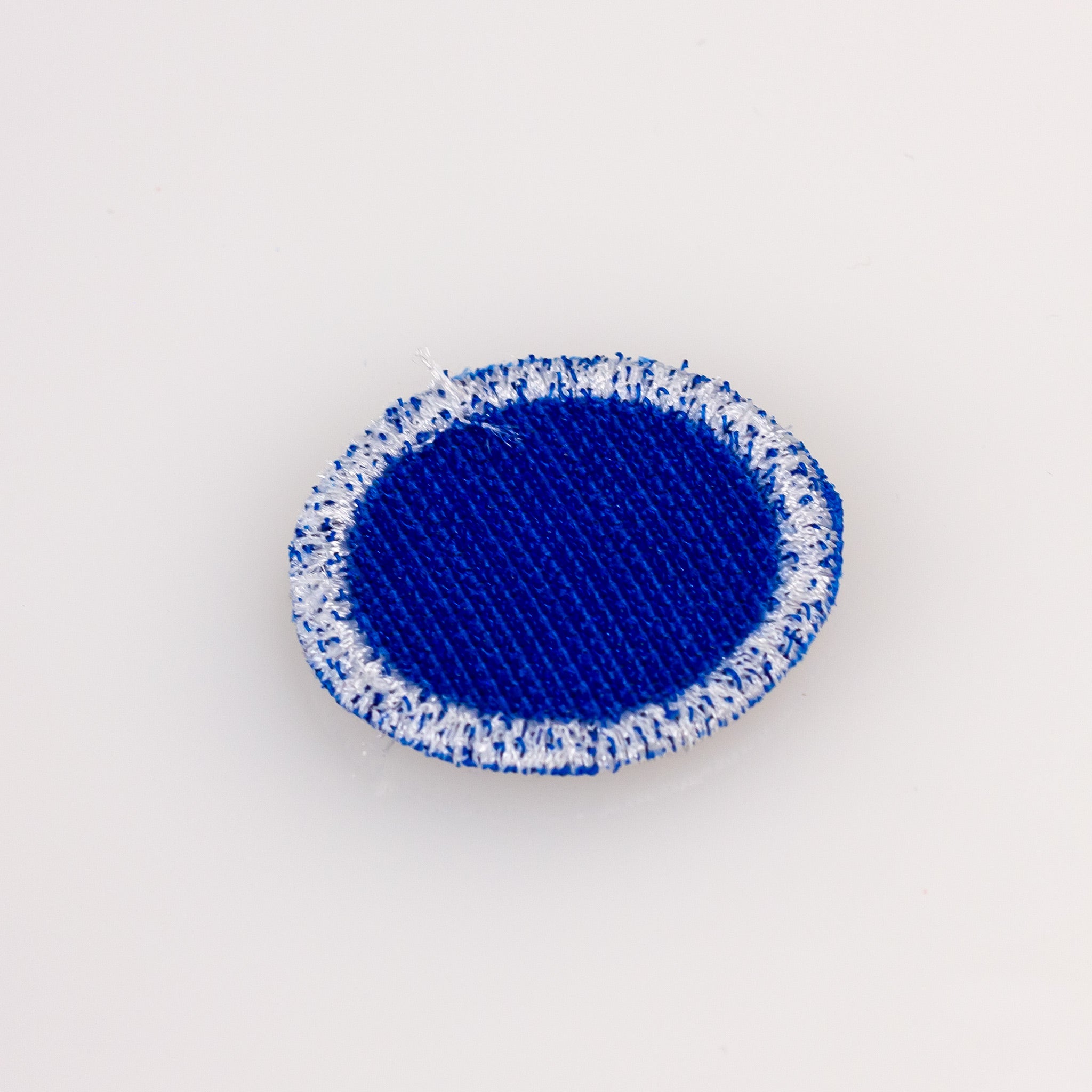 Blue headcover patch for golf clubs, featuring a sleek design.