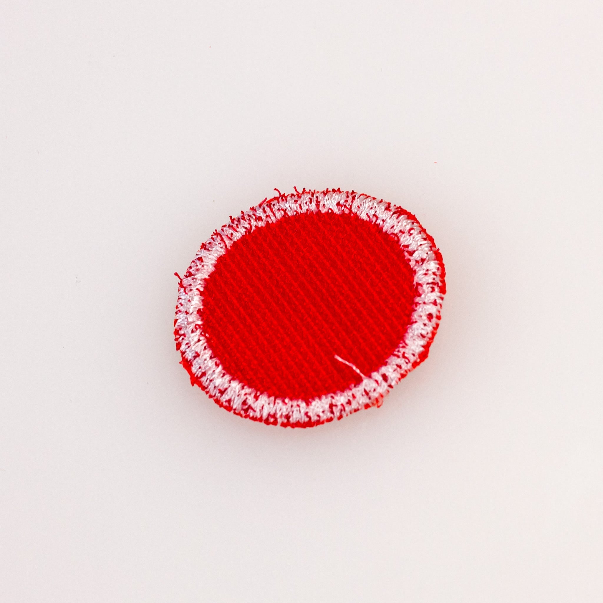 Red headcover patch featuring a bold design, perfect for personalizing golf gear.
