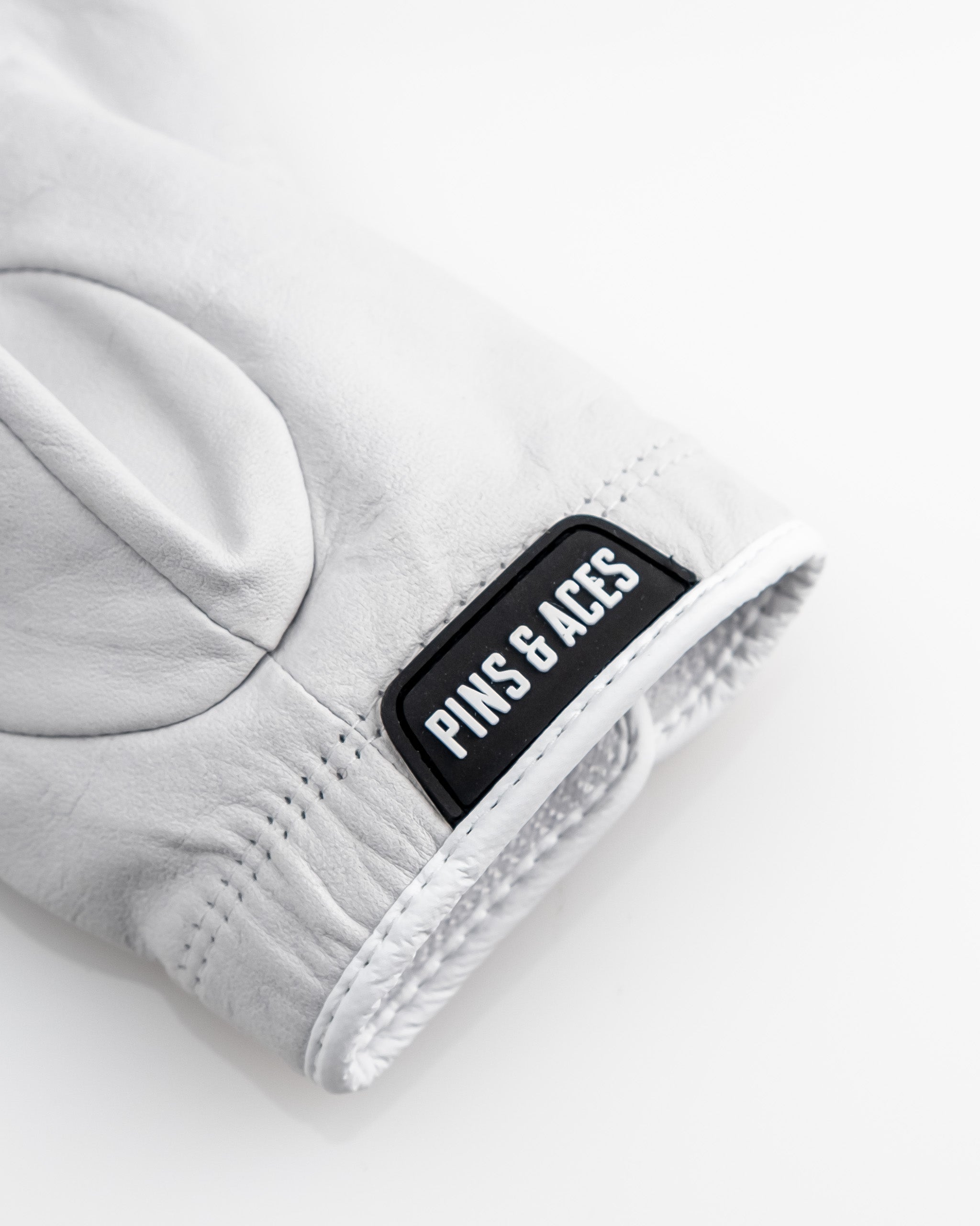 Premium Tour Glove in Ghost White, showcasing sleek design and quality material suitable for golf enthusiasts.