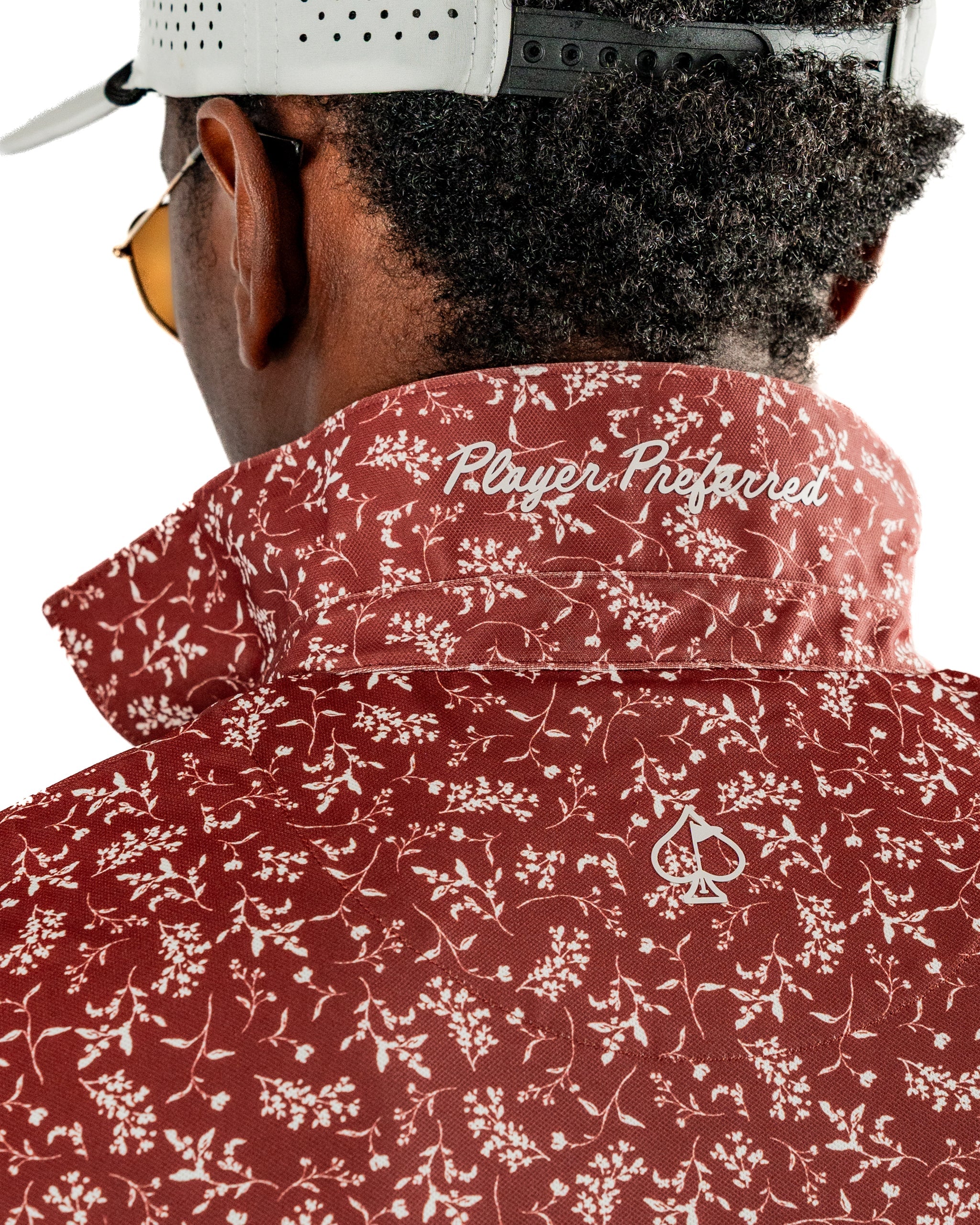 Close-up of the collar of the Autumn Bloom golf jacket featuring a floral pattern and "Player Prepared" embroidery.