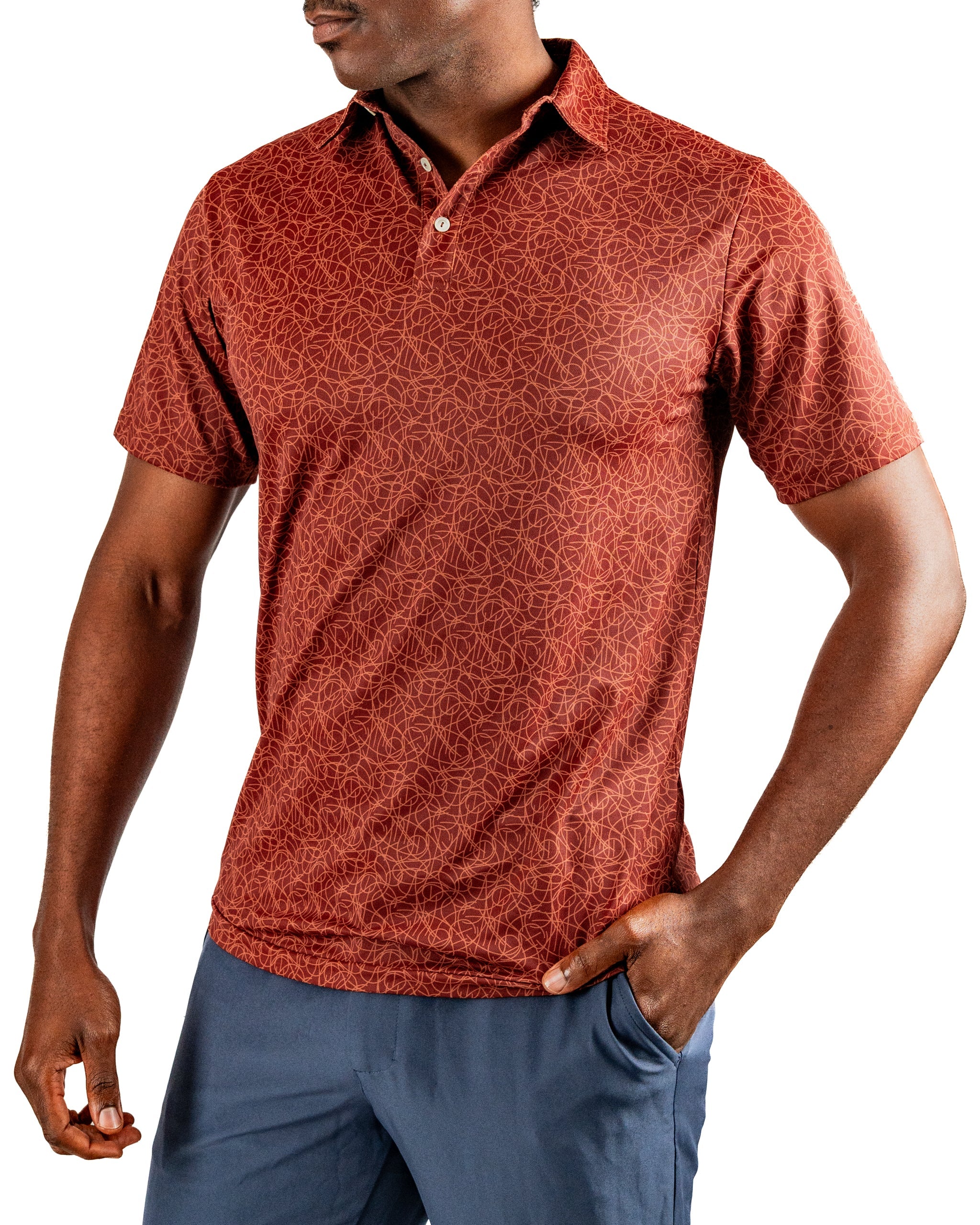 Men's short-sleeve golf polo in a rich red color with a subtle geometric pattern, paired with blue golf shorts.