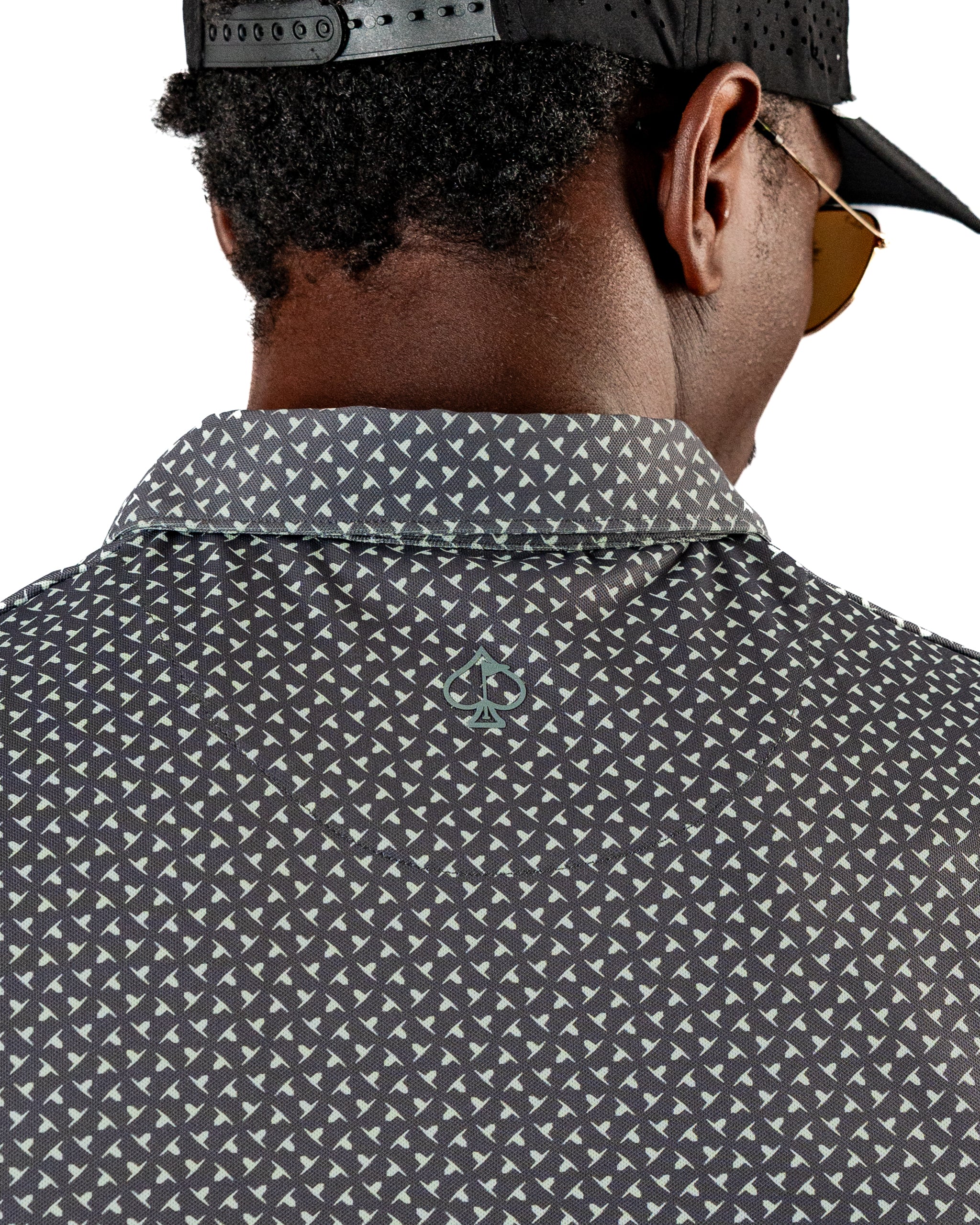 Men's Jade Drops golf polo featuring a unique geometric pattern and logo on the back, designed for stylish performance on the course.