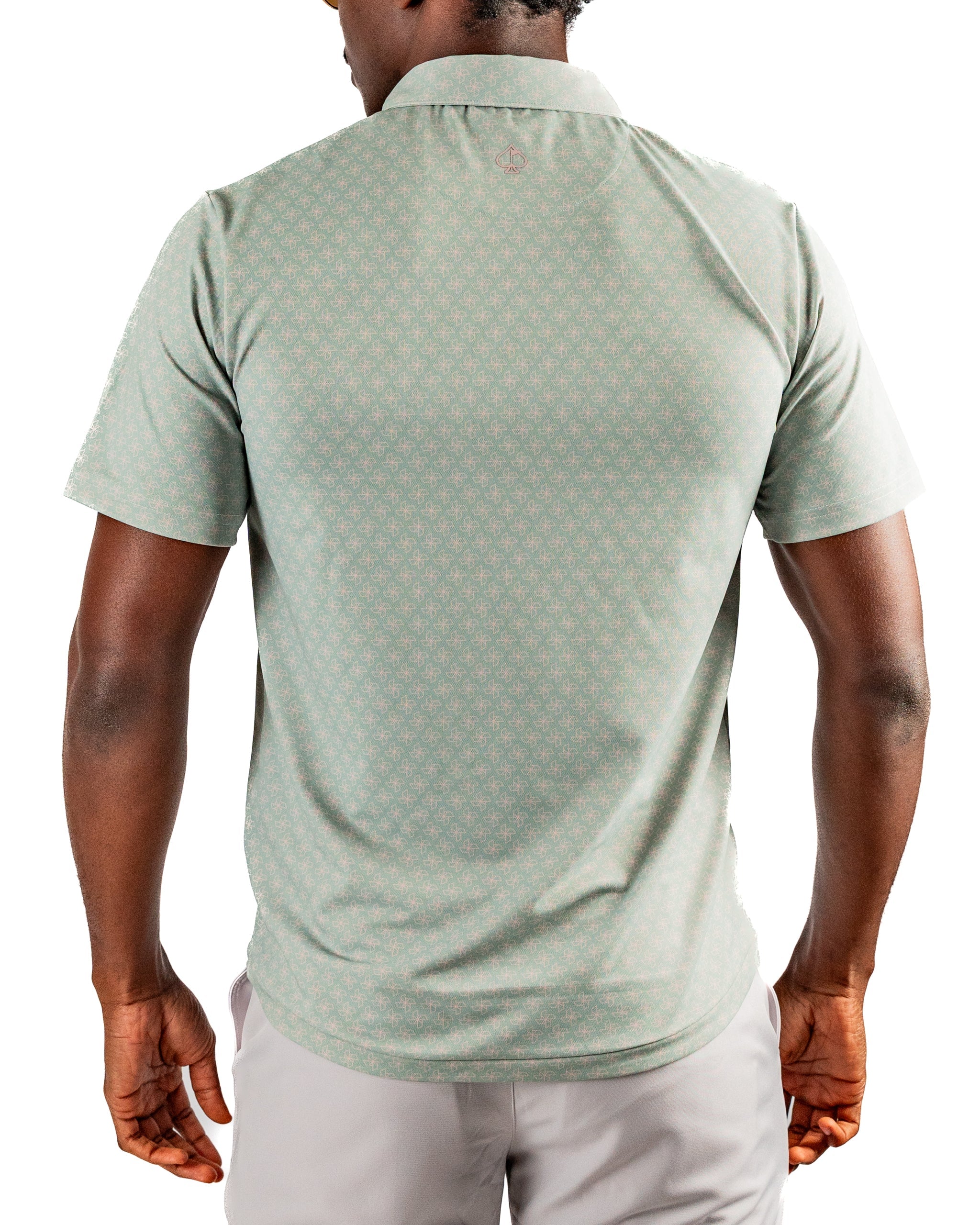 Men's short-sleeve golf shirt in a light green color with a subtle origami pattern, featuring a classic polo collar and relaxed fit.