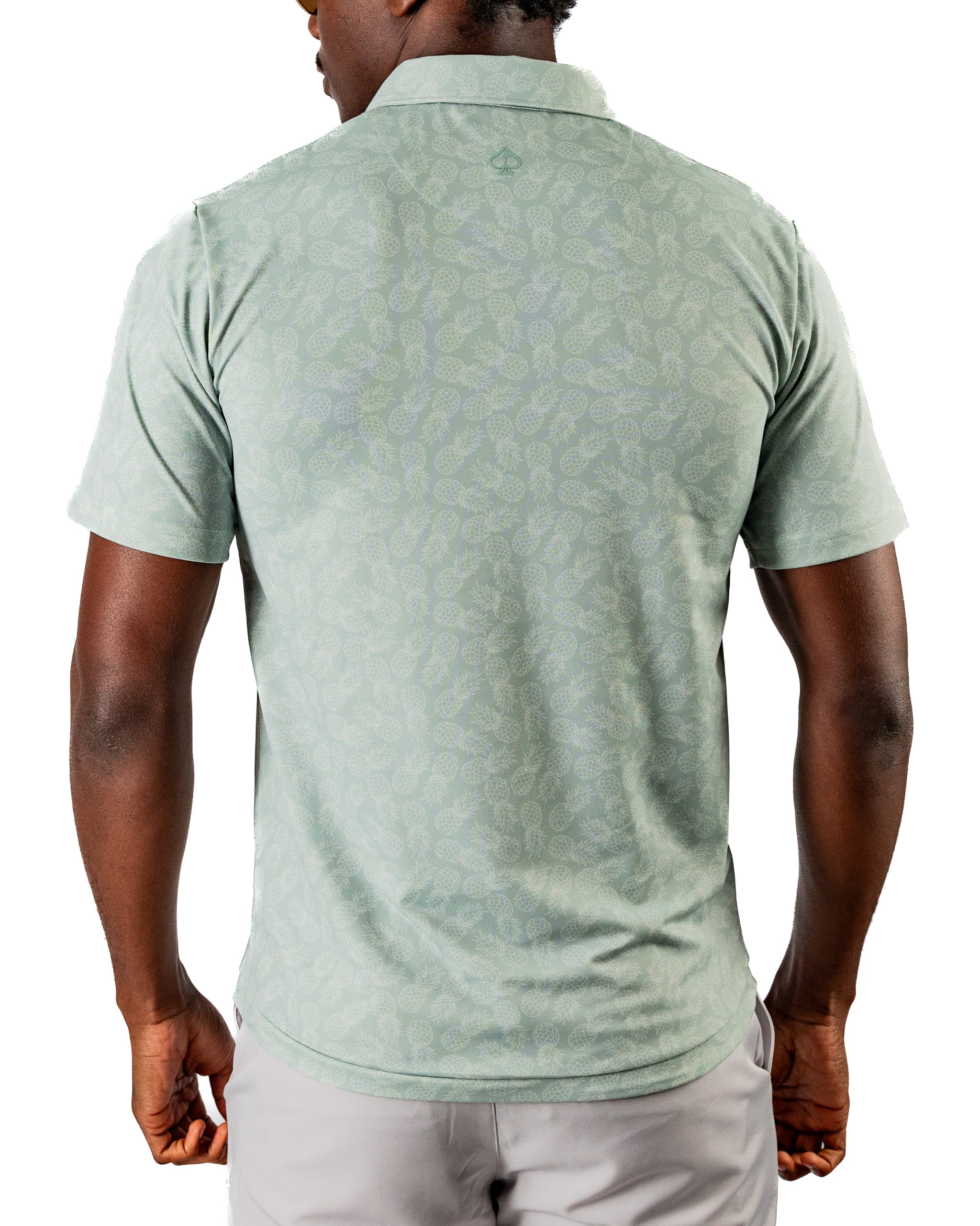 Men's short-sleeve golf polo shirt in light green with a subtle pineapple pattern, designed for a stylish look on the course.