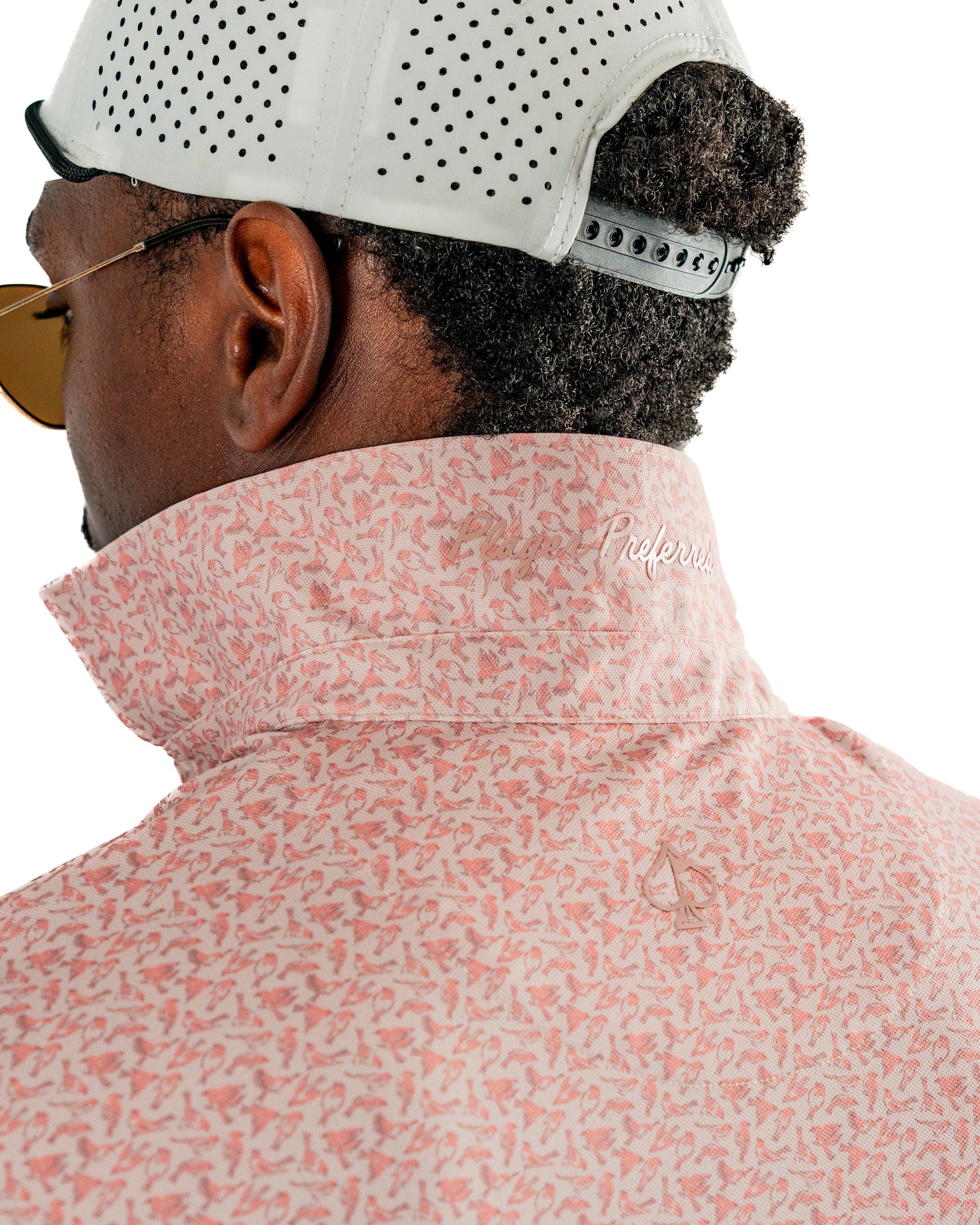 Men's pink golf shirt featuring a subtle sparrow pattern and a stylish high collar, perfect for a bold look on the course.