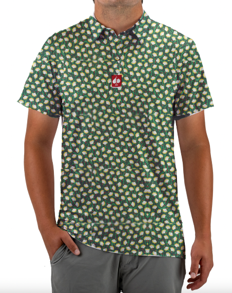 Bold short-sleeve golf shirt featuring a vibrant pimento pattern on a green background, perfect for stylish golfers.