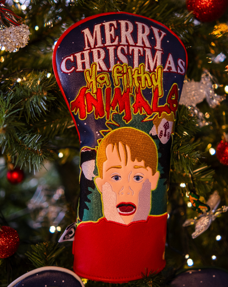 Bold driver cover featuring a playful design with a child’s face and festive "Merry Christmas Ya Filthy Animal" text.