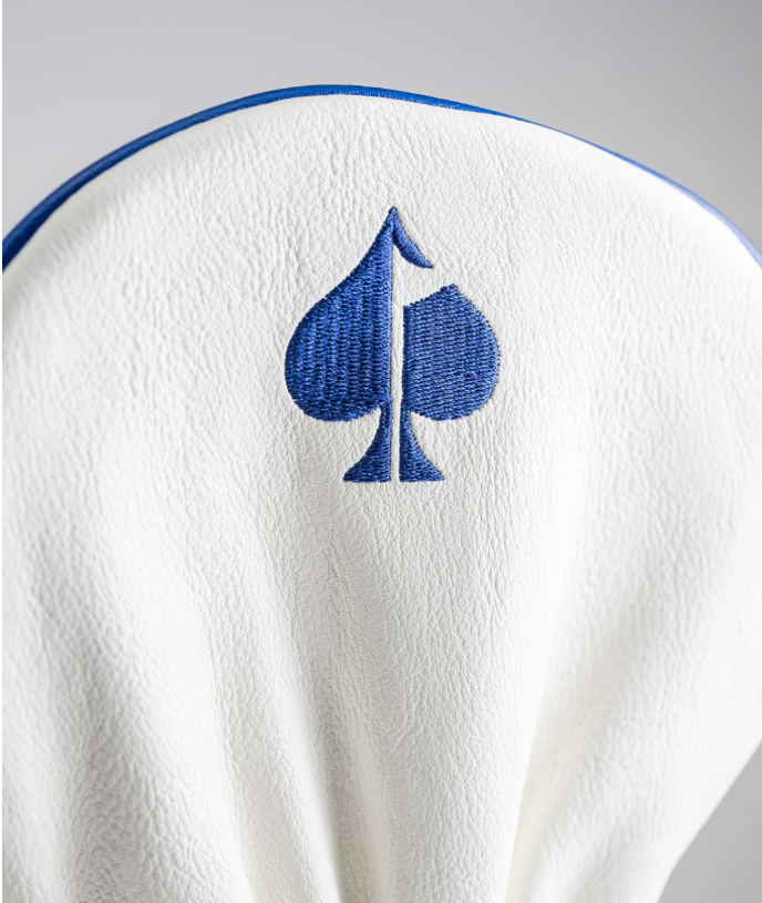Betsy Ross driver cover featuring a blue spade logo on a textured white background, designed for stylish golfers.