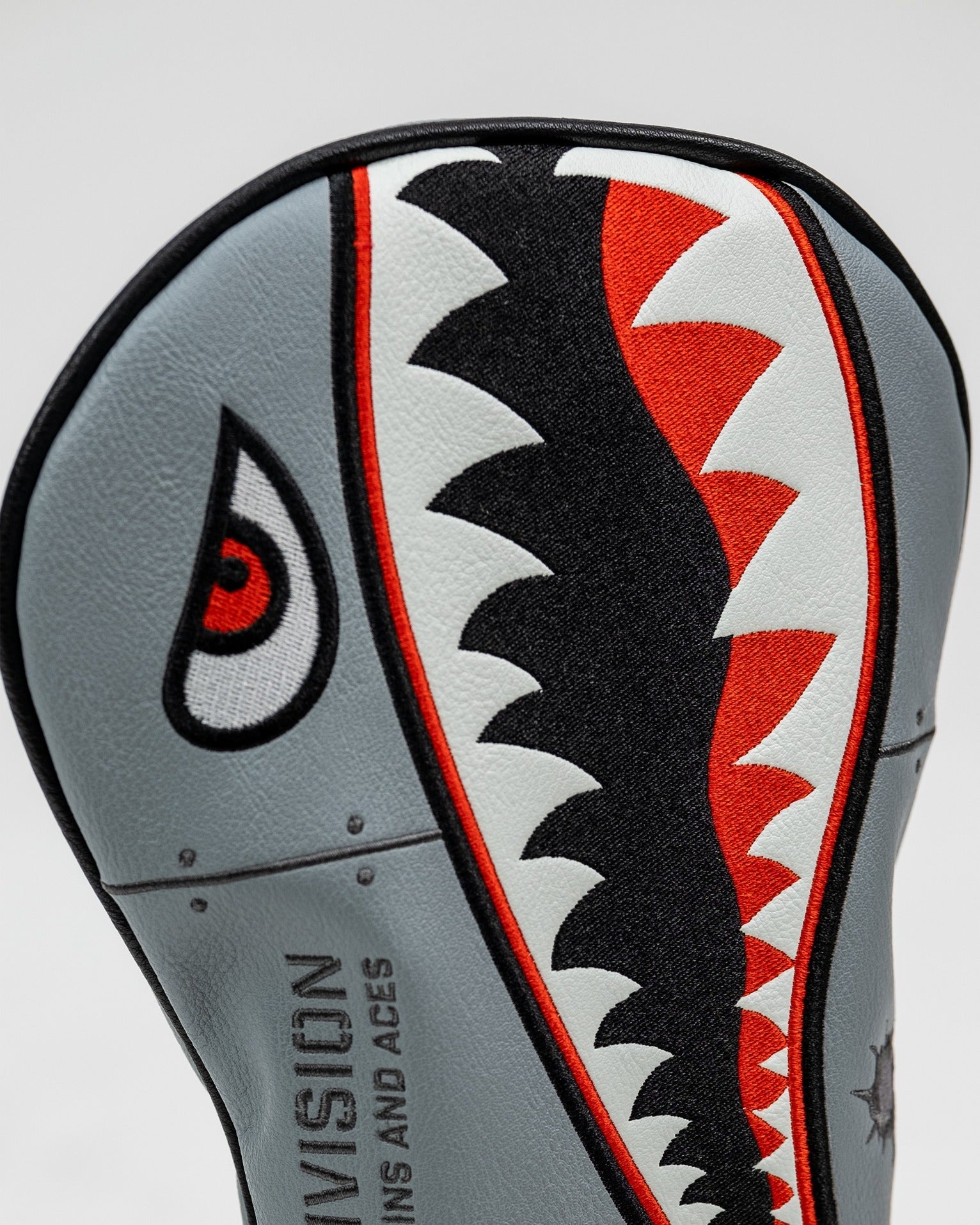 Bold bomber driver cover featuring a striking shark design with red and black accents, perfect for standout golf style.