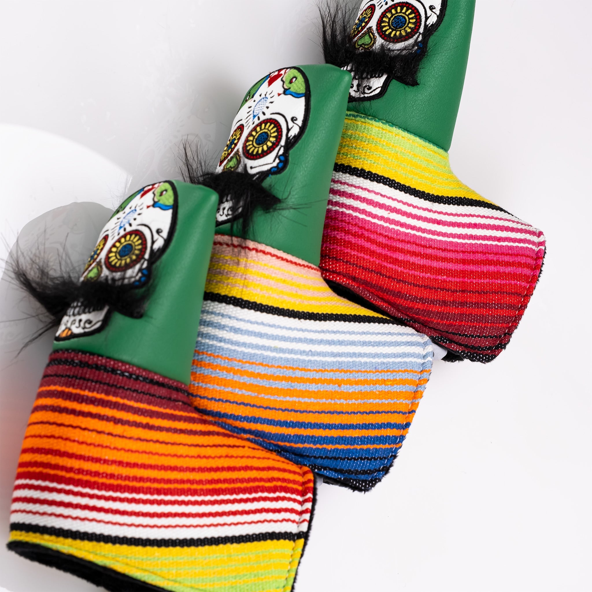 Colorful Mustache Sugar Skull blade putter cover in green, featuring vibrant striped patterns and playful details.