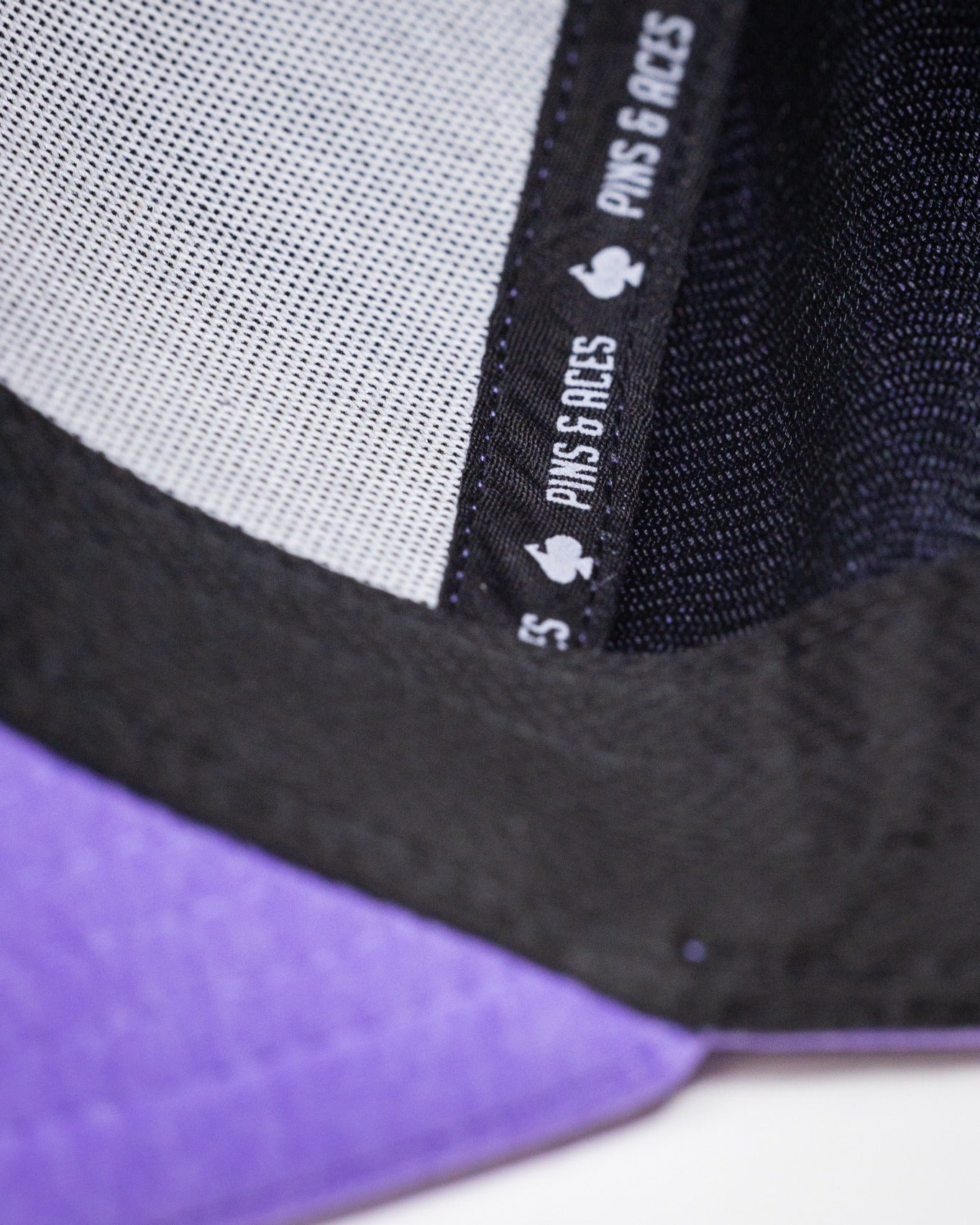 Lavender Performance Spade Hat featuring a breathable mesh lining and stylish black accents for golfers.