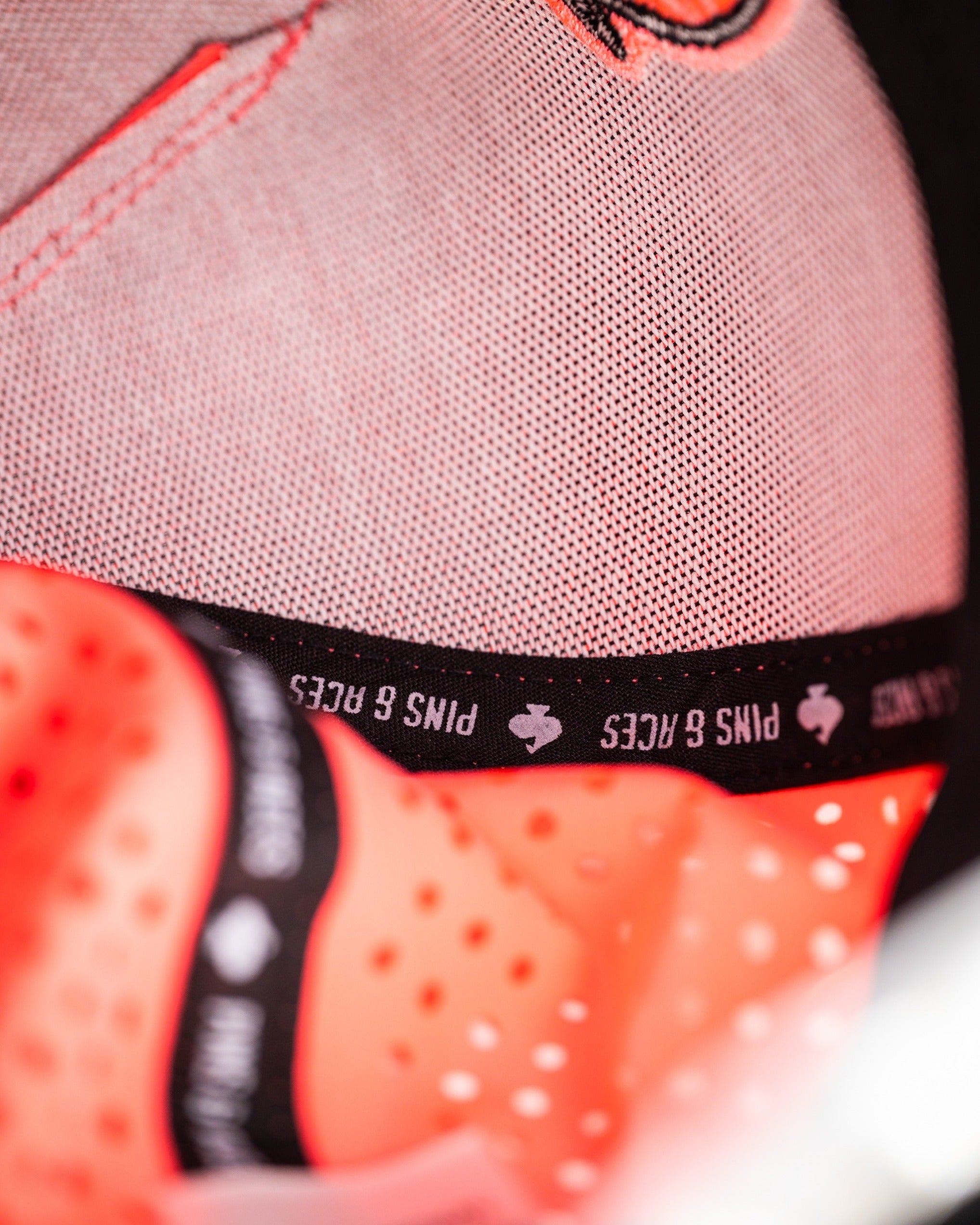 Highlighter pink perforated rope hat featuring a breathable design and Pins and Aces branding on the interior.