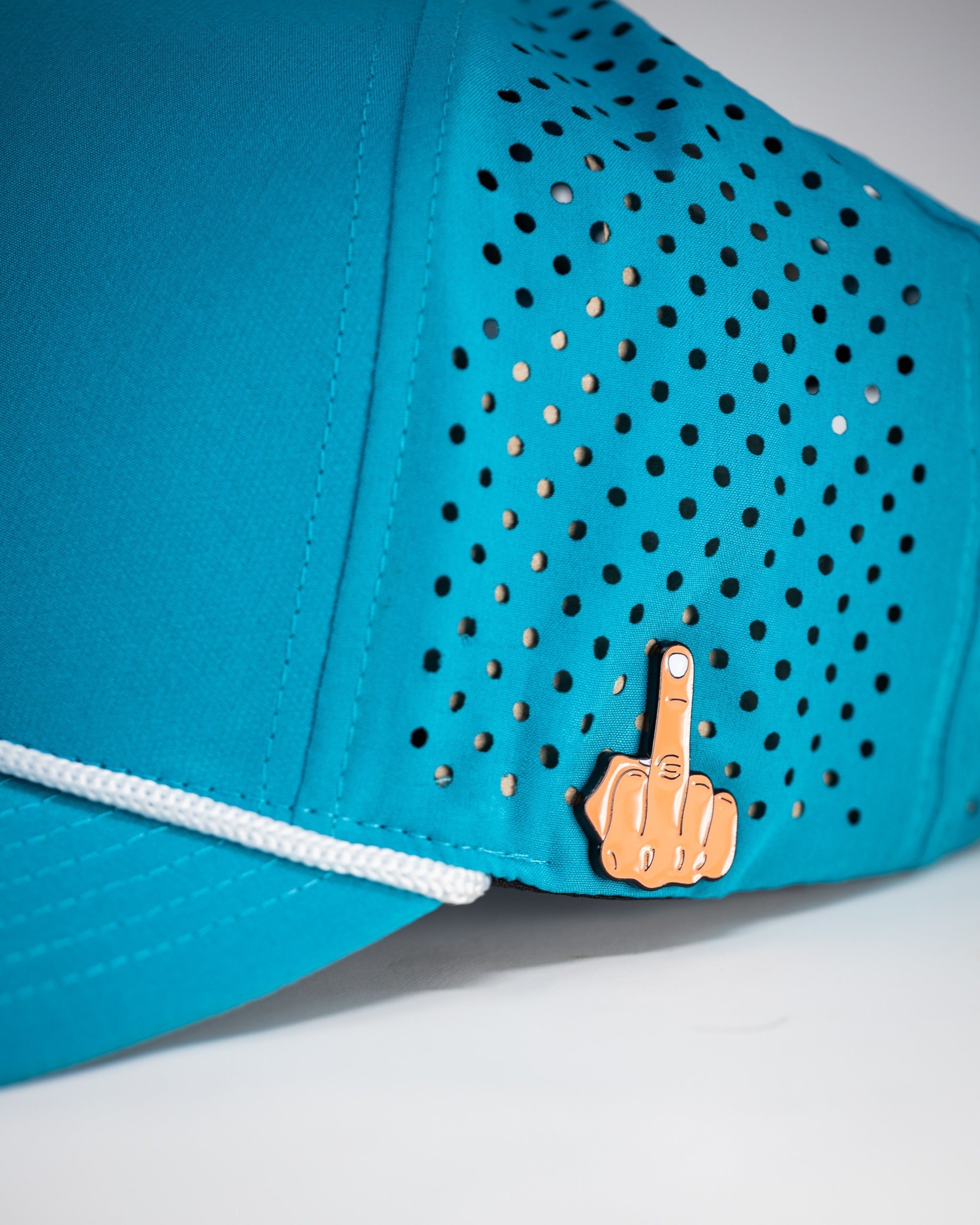 Perforated baby blue rope hat featuring a unique finger gesture pin for a bold golf style. Ideal for standout golfers.
