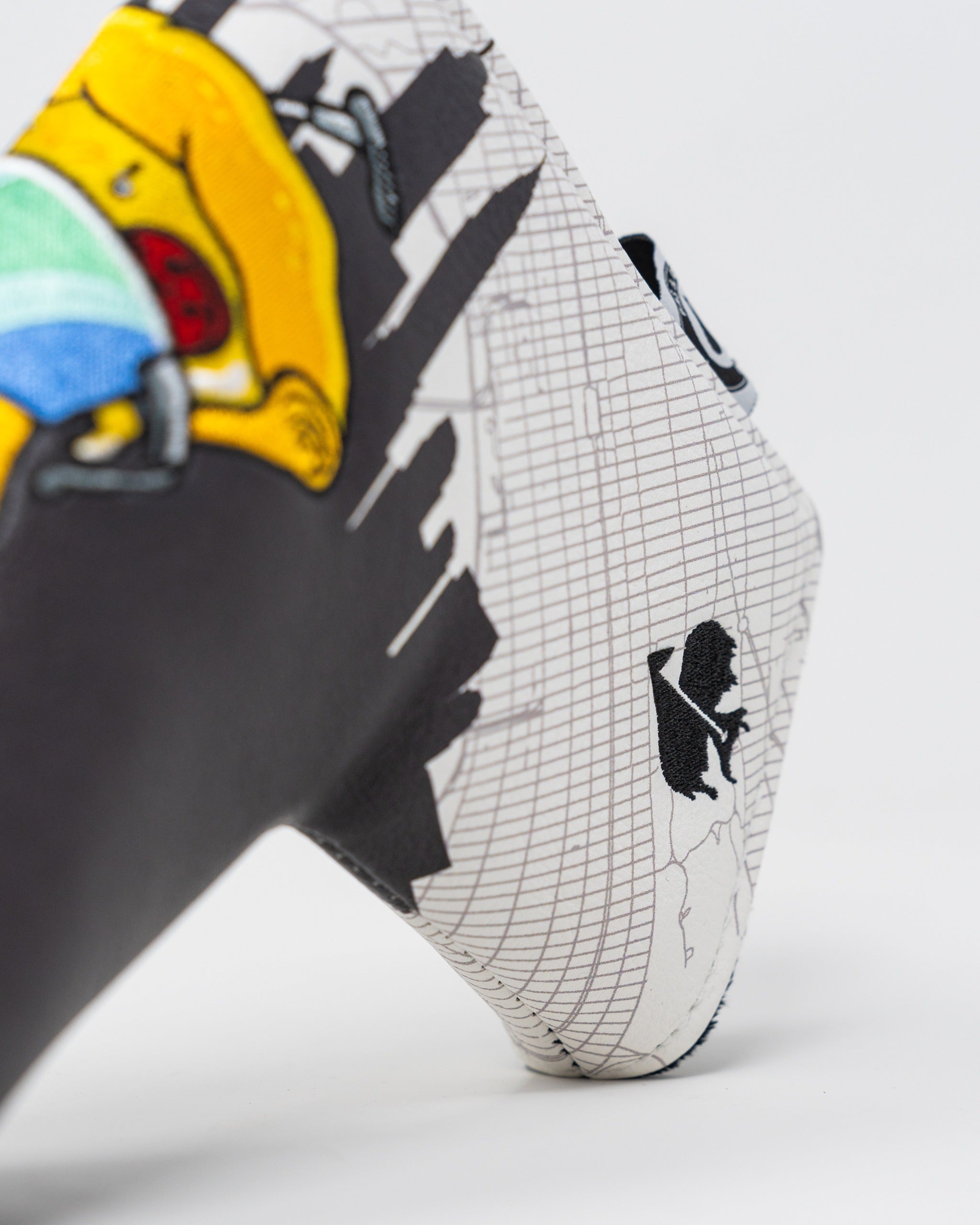 Colorful Shady Slice Blade Putter Cover featuring playful cartoon designs and a unique graphic pattern for standout style on the course.