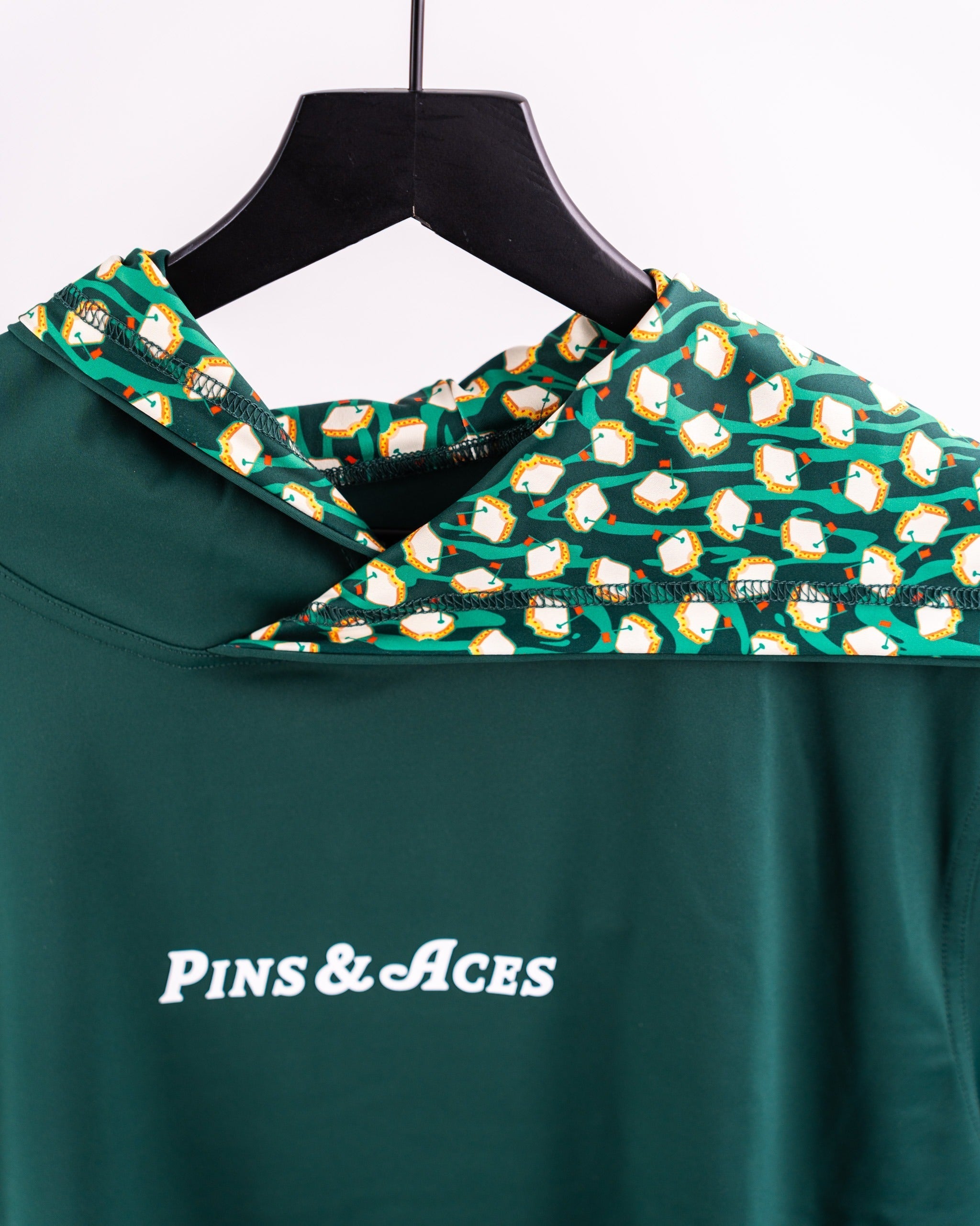 Performance Golf Hoodie in Pimento 4.0 features a vibrant green design with a playful patterned hood, ideal for stylish golfers.