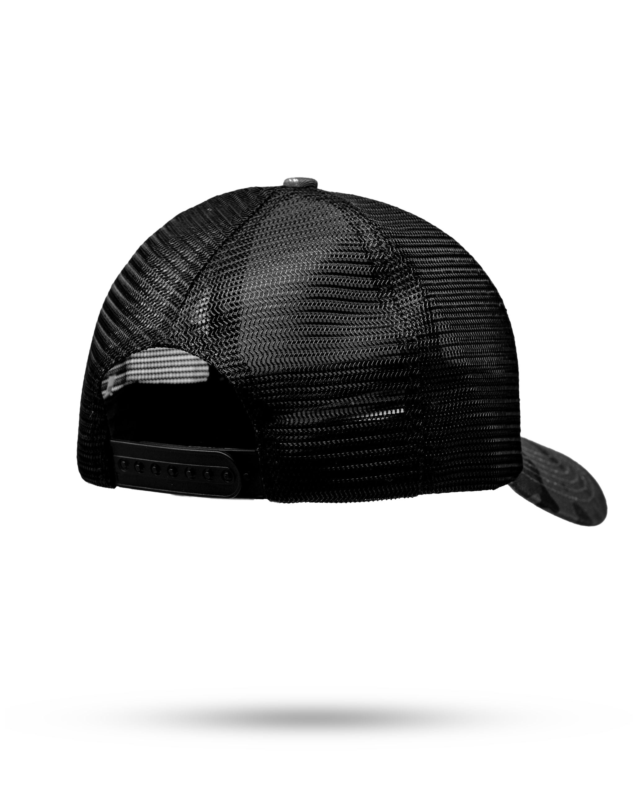 Trucker hat in urban camo design featuring a mesh back and adjustable snap closure for a comfortable fit.