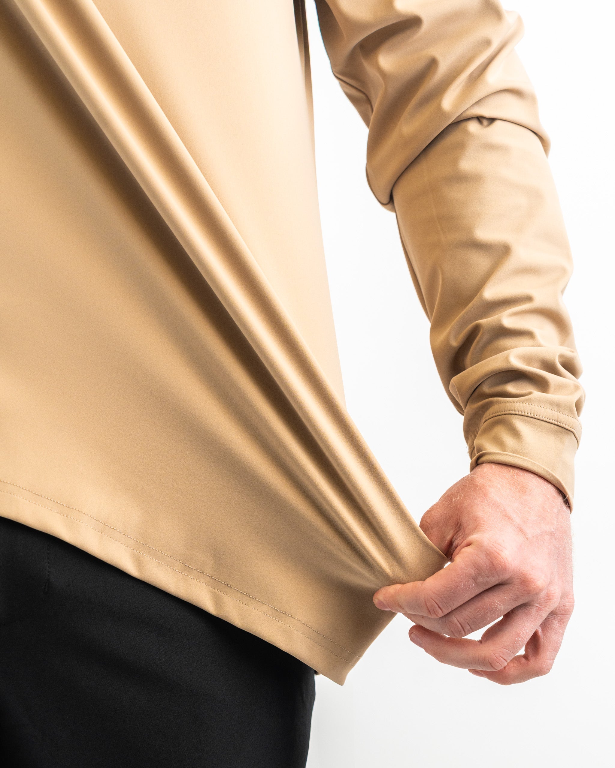 Performance golf hoodie in sand color, showcasing a close-up of the fabric's smooth texture and fit. Ideal for golfers.