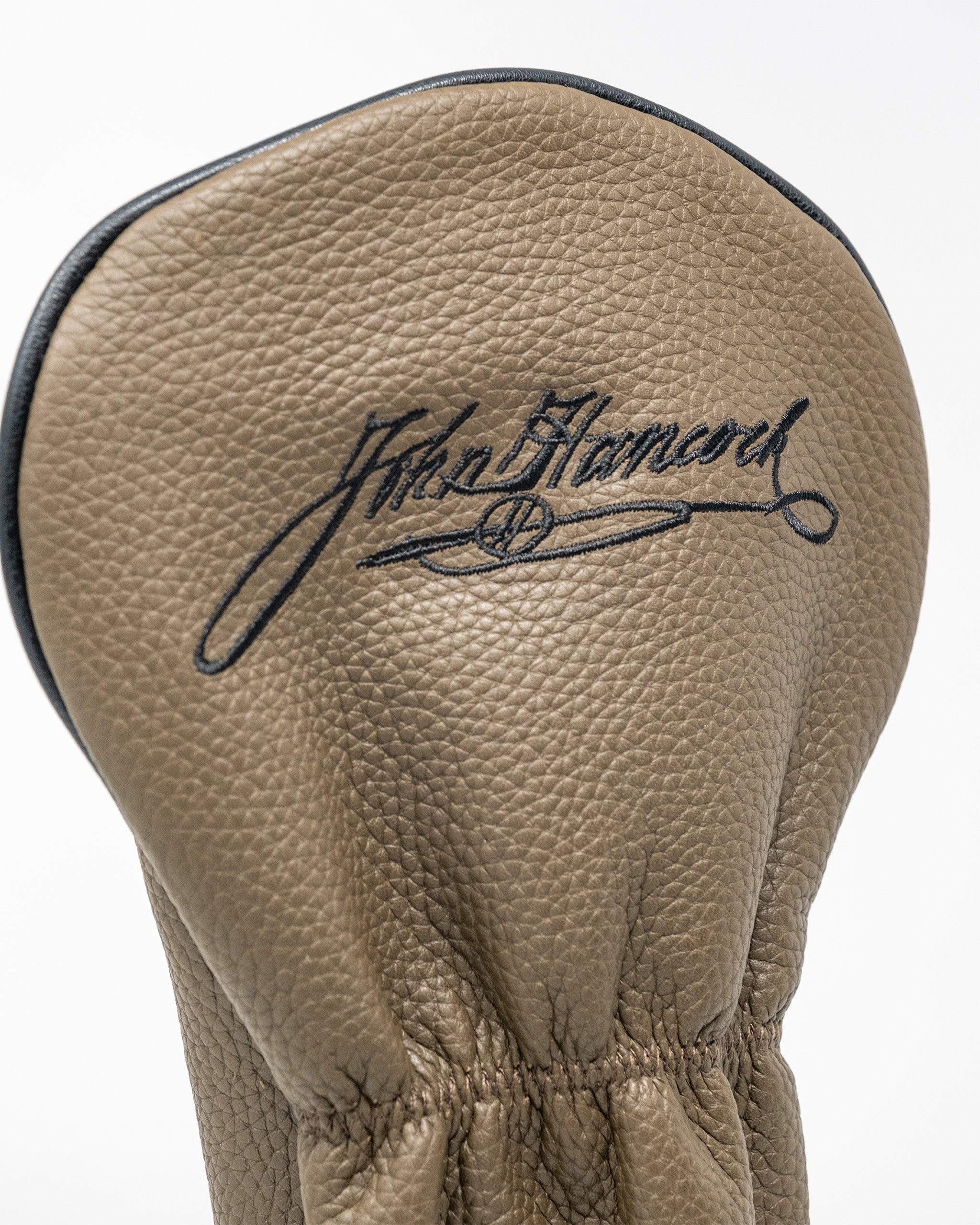 Stylish driver cover in tan leather featuring an embossed signature design, perfect for golfers who want to stand out.