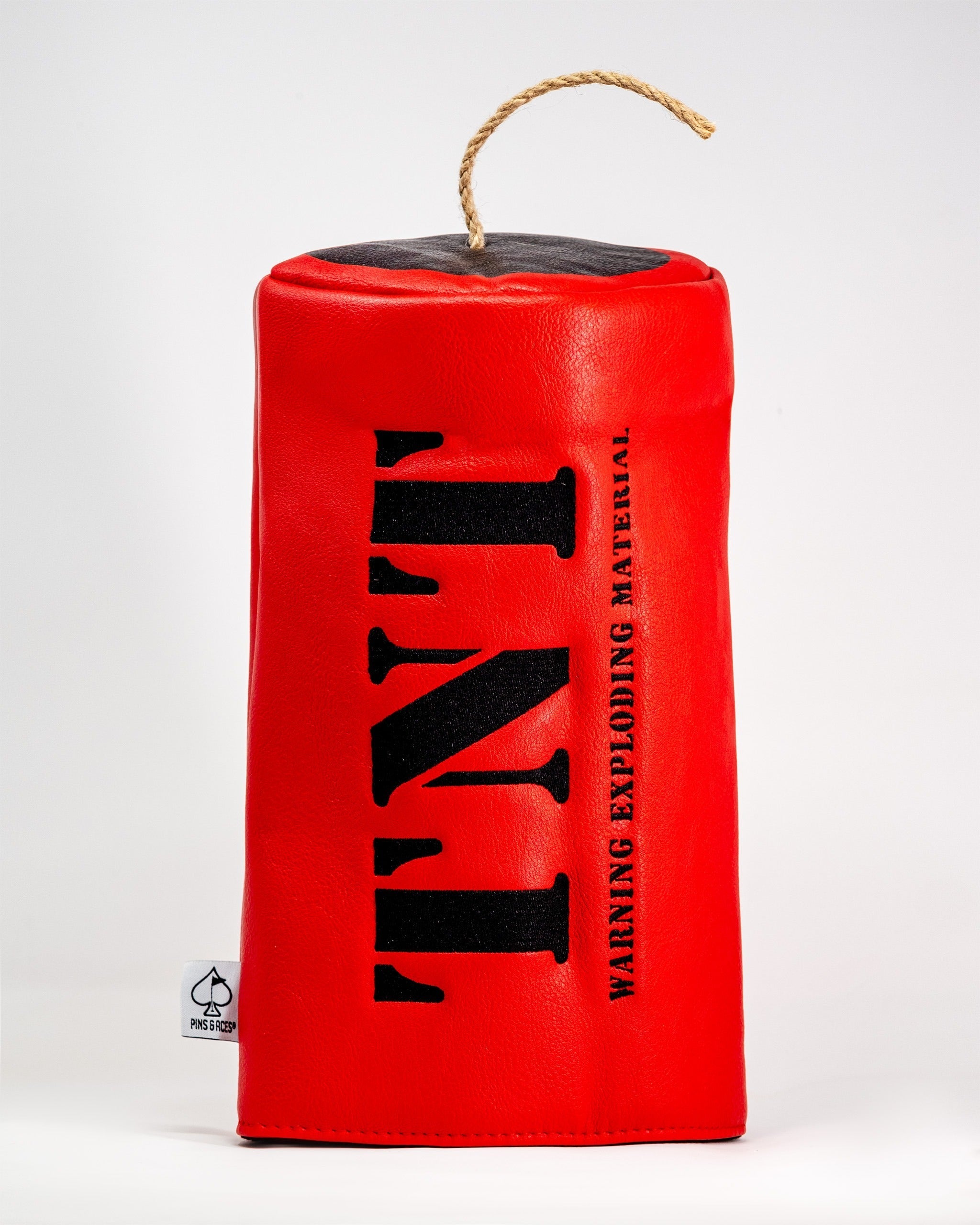 Bold red driver cover with "TNT" printed in black, featuring a warning label and a decorative rope handle.