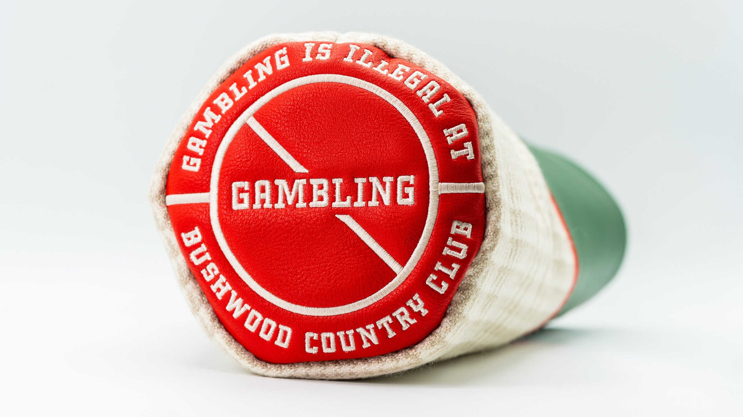 Bold Bushwood Country Club driver cover featuring a red and white design with the phrase "Gambling is illegal at Bushwood.