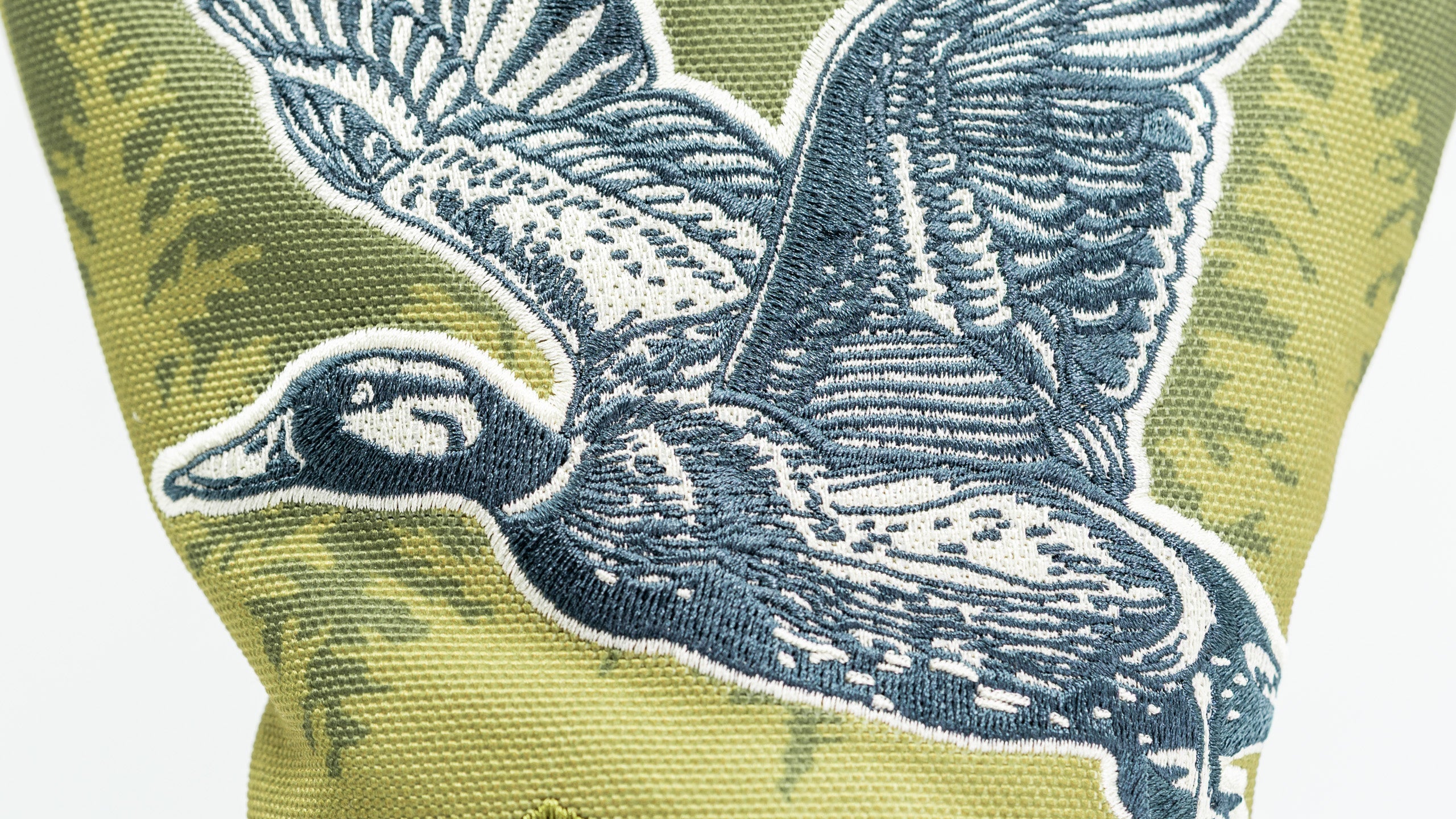 Open Season Mallard driver cover featuring an intricately embroidered flying duck design on a textured green background.