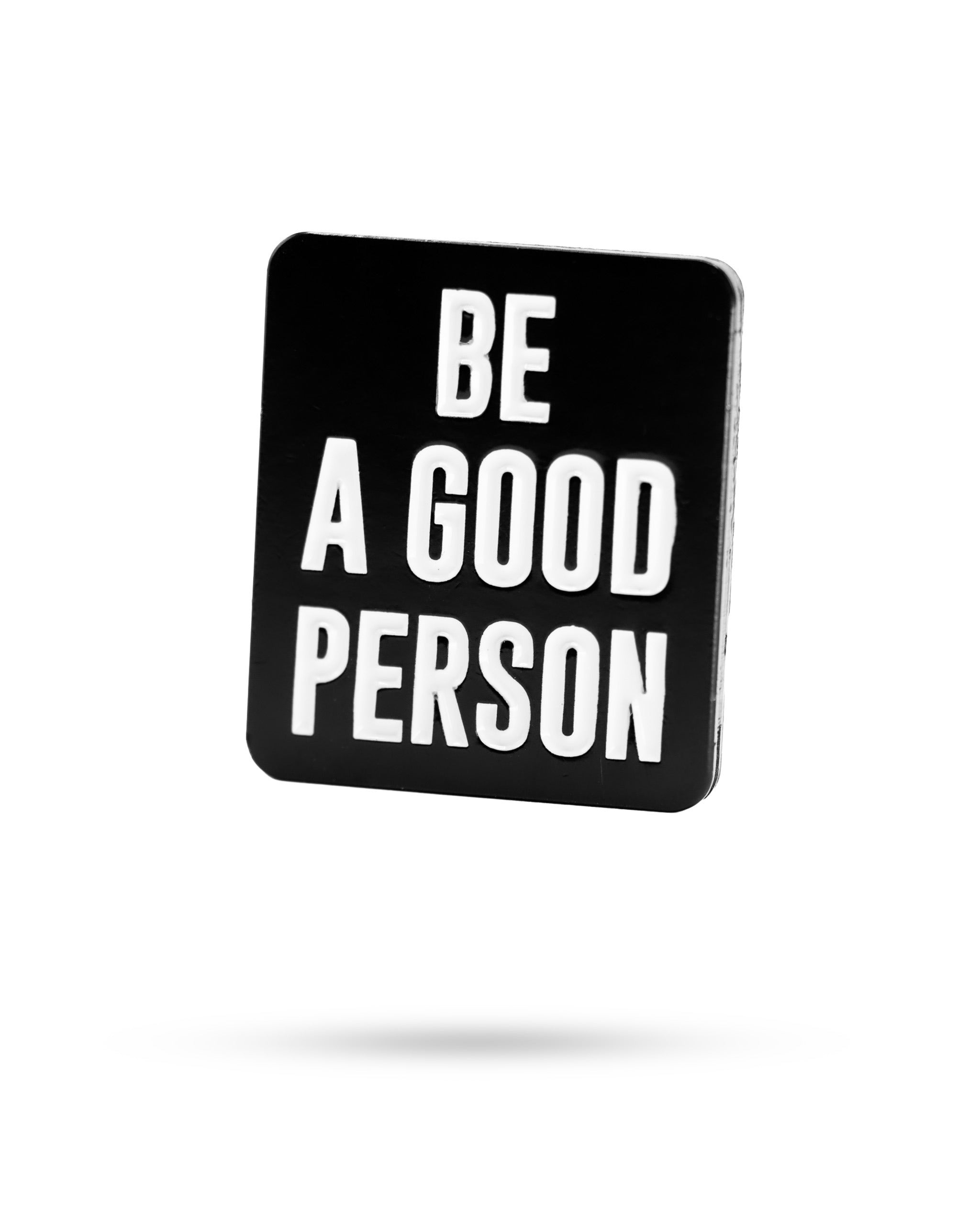 Black ball marker featuring the phrase "Be A Good Person" in bold white letters, designed for golfers who value positivity.