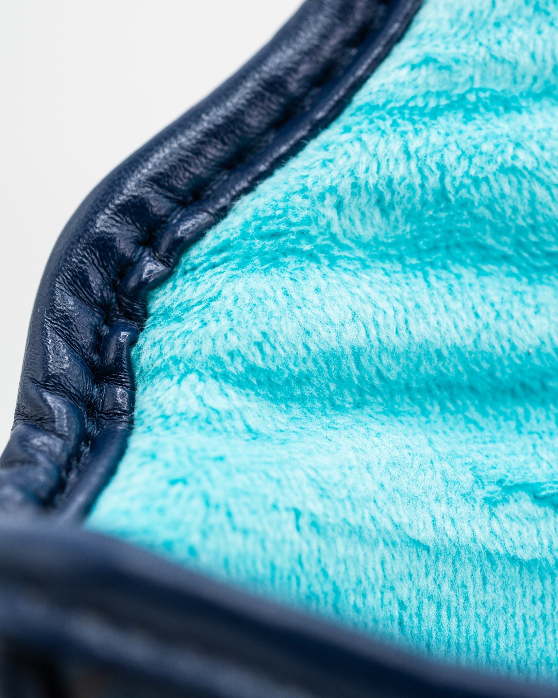 Close-up of the Kraken mallet putter cover showcasing its soft turquoise interior and durable navy exterior.