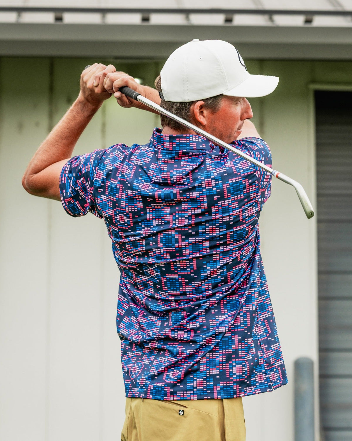 Bold Tetrafloral Dark golf shirt featuring a vibrant geometric pattern, perfect for stylish golfers on the course.
