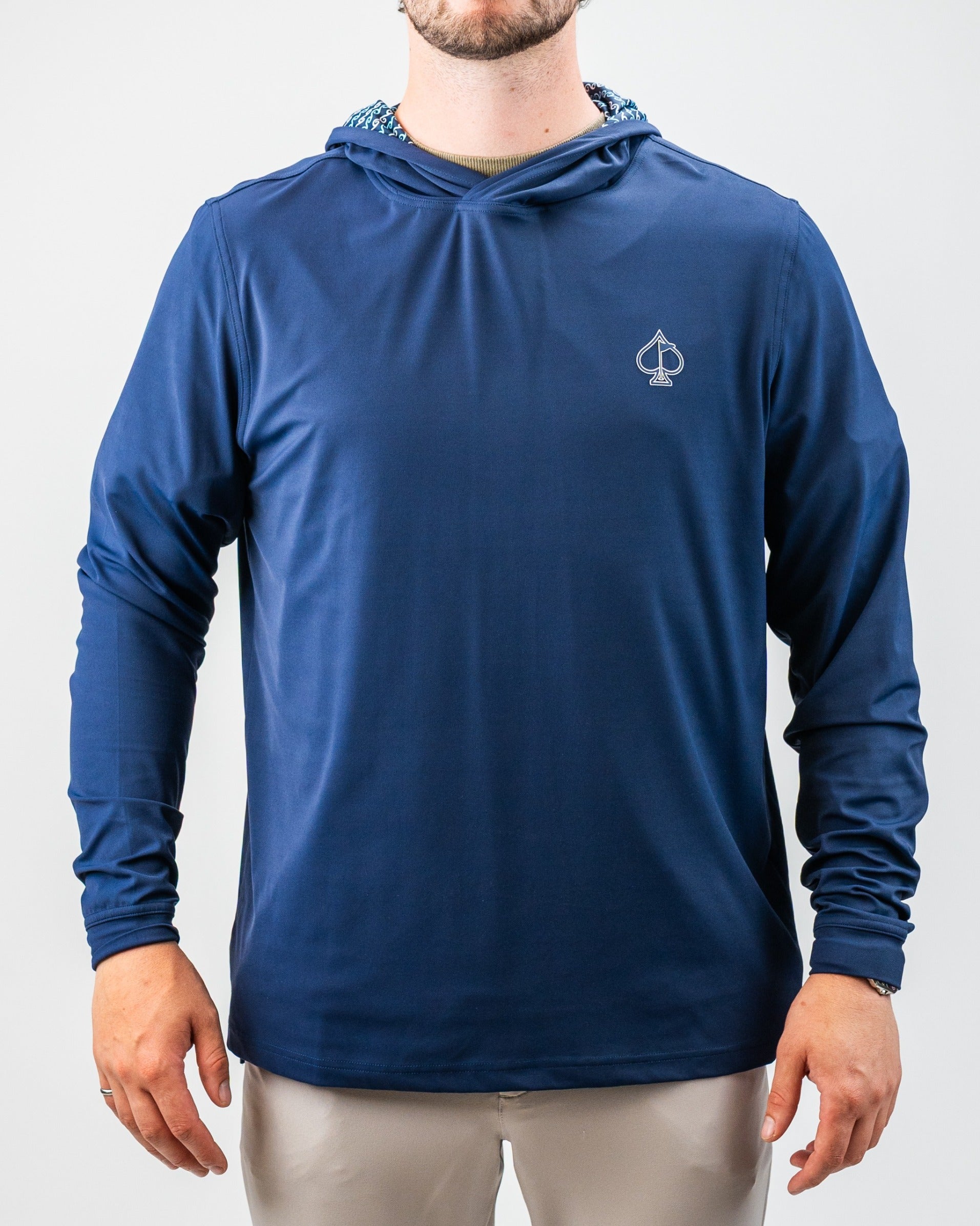 Blue athletic hoodie with a small spade logo, lightweight, sporty design, and a patterned hood lining for bold golf style.