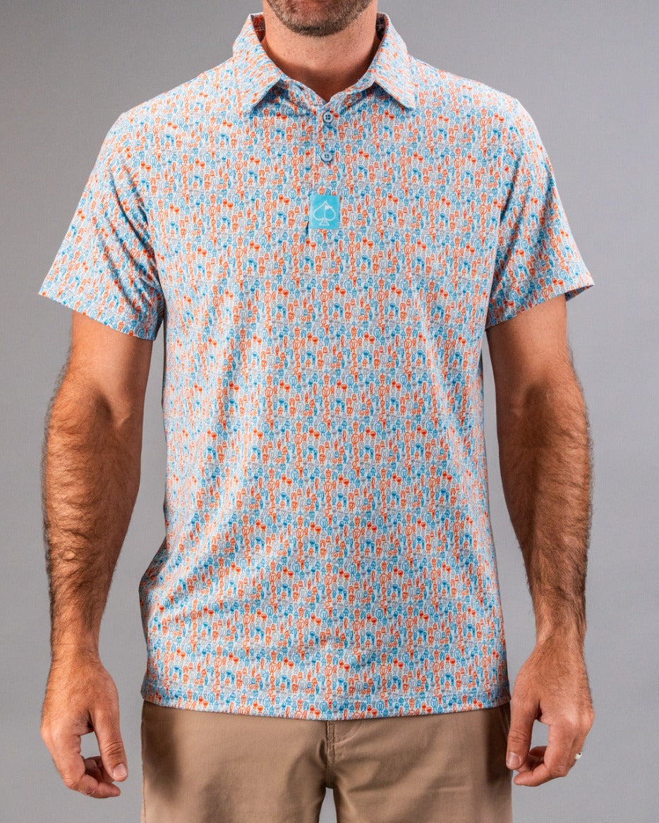 Bold, patterned golf shirt with blue, orange, and white print, featuring a small blue logo tag, perfect for standout golf ...