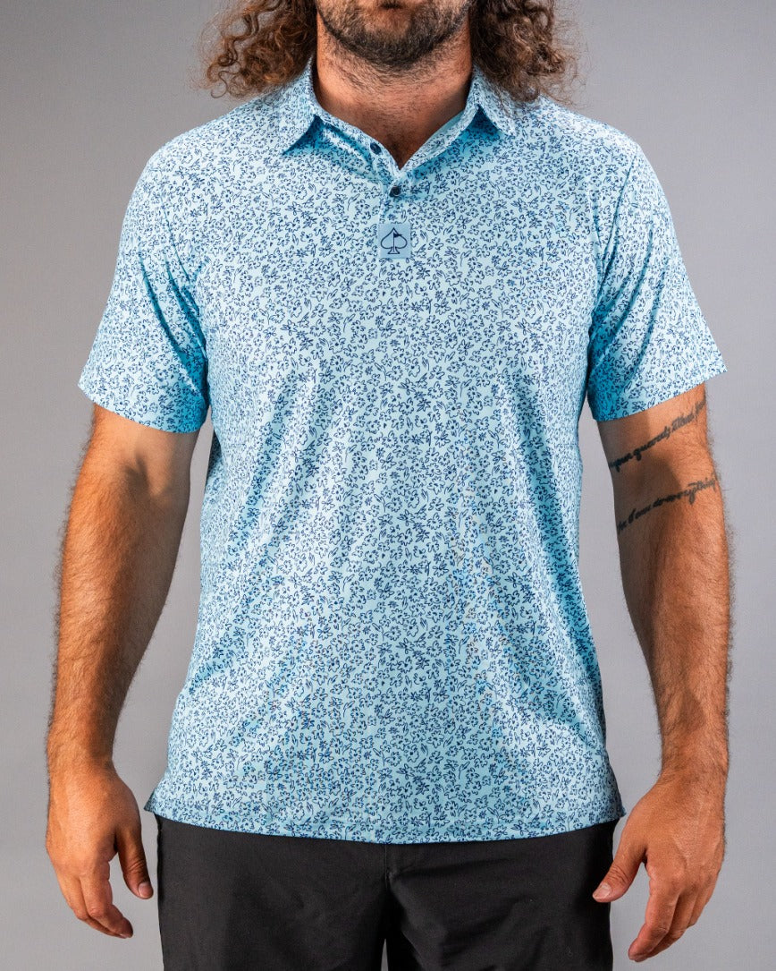 Men's short-sleeve golf shirt in light blue with a floral doodle pattern, perfect for stylish play on the course.